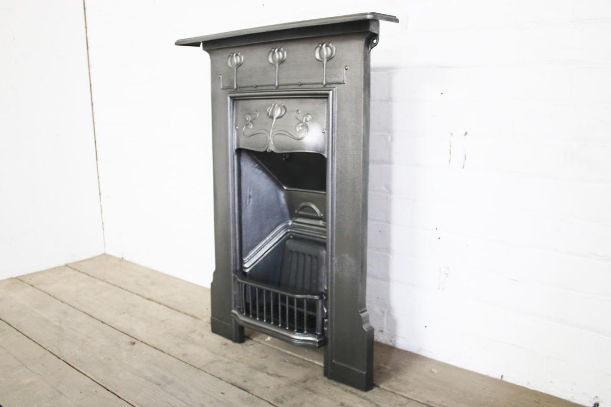 Small antique Edwardian Art Nouveau cast iron combination grate, circa 1905-1910 

Finished in traditional black grate polish to give a gun metal / pewter look. 
We currently have a suite of these fireplaces available.