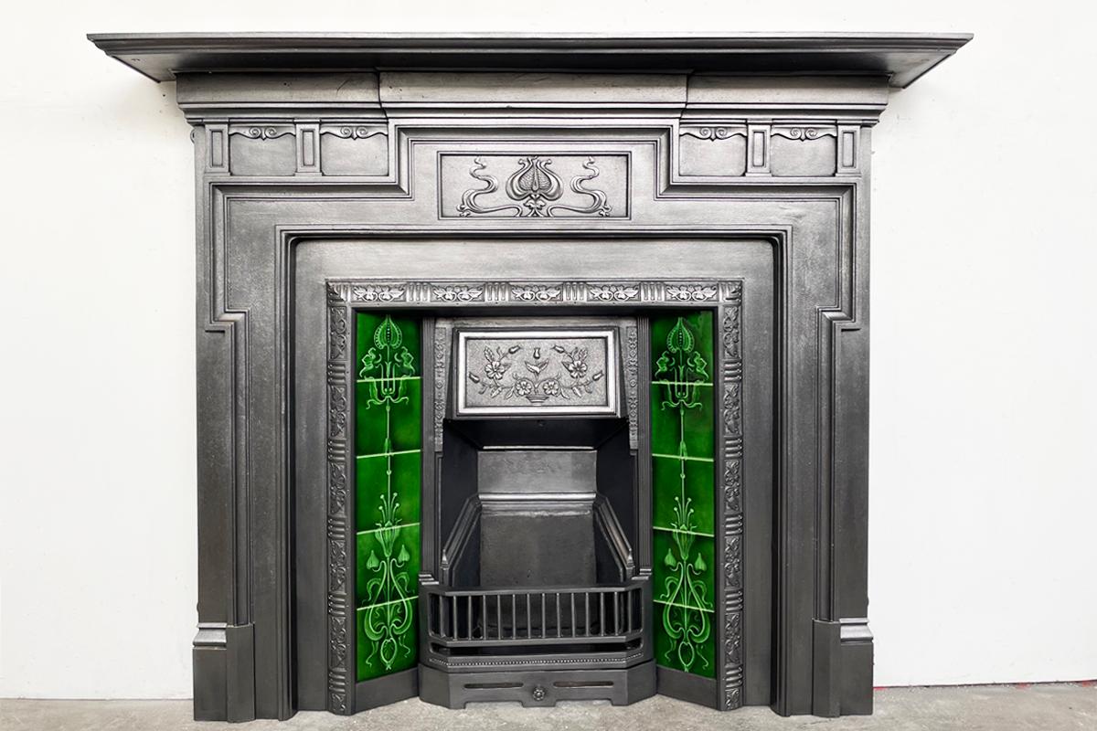 Restored antique Edwardian Art Nouveau cast iron fireplace surround with a styalised tulip to the frieze, and dog leg moulding frames the aperture. Dated 1902-1906.

For detailed sizes please see the size diagram in the image gallery.

The surround