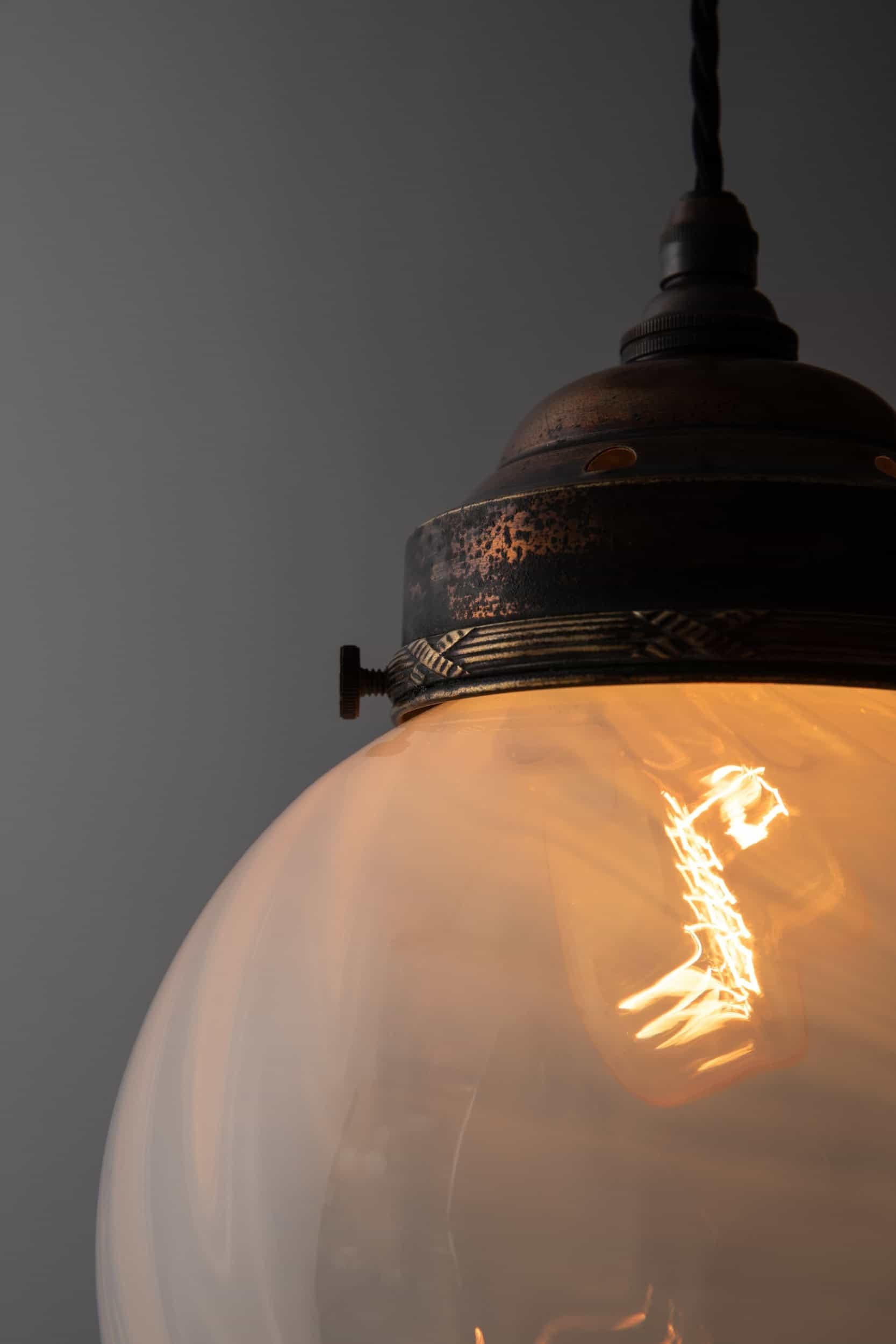 A beautiful arts & crafts period vaseline globe pendant light. c.1910

Of beautiful design and form, hand-crafted swirled glass blown into a globe shape with a blue tint, topped with an elegant copper gallery having the most amazing patina!

Rewired