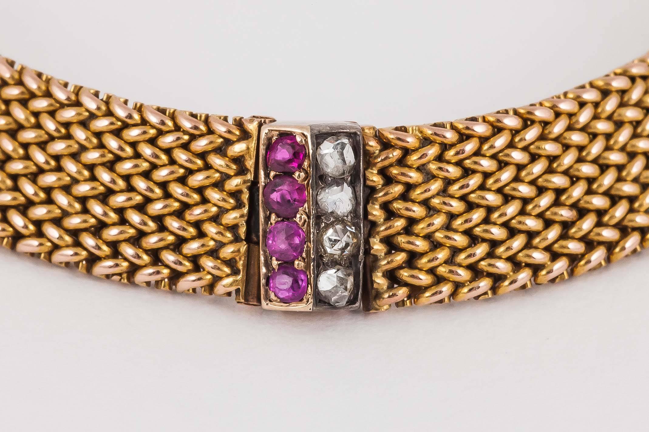Bracelet in 14 karat yellow gold of mesh design, set with six Burma ruby and rose-cut diamond motifs.
Measures 8mm in width x 195mm in length.
Antique piece (over 100 years old).
Early 20th century, Austrian circa 1900-10.

Stock no. 1588