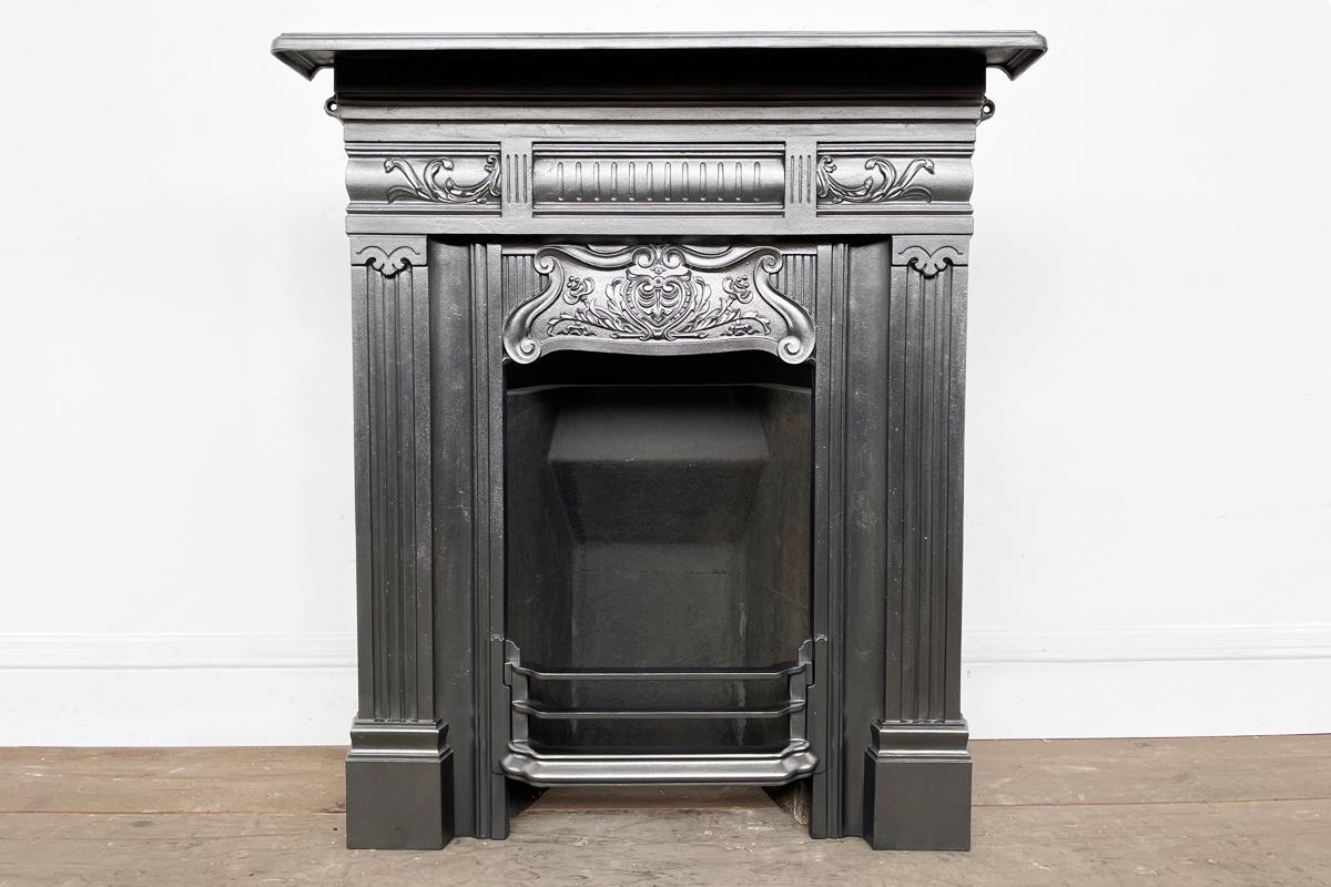 Very pretty antique Edwardian cast iron bedroom combination fireplace.

Finished in traditional black grate polish and supplied with a new clay fireback and cast iron bottom grate.

We currently have a pair of these fireplaces available.