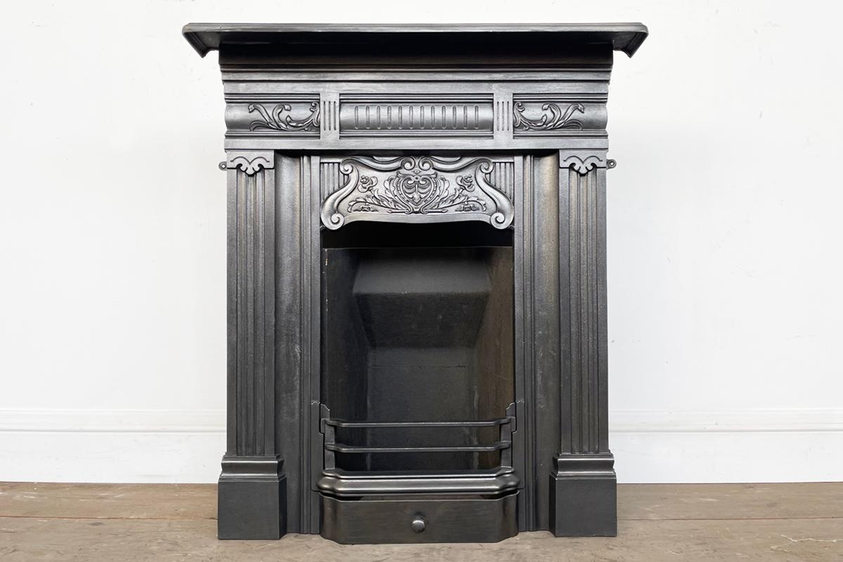 Very pretty antique Edwardian cast iron bedroom combination fireplace. Circa 1900.

Finished in traditional black grate polish and supplied with a new clay fireback and cast iron bottom grate and steel ash cover.

For detailed sizes see the size