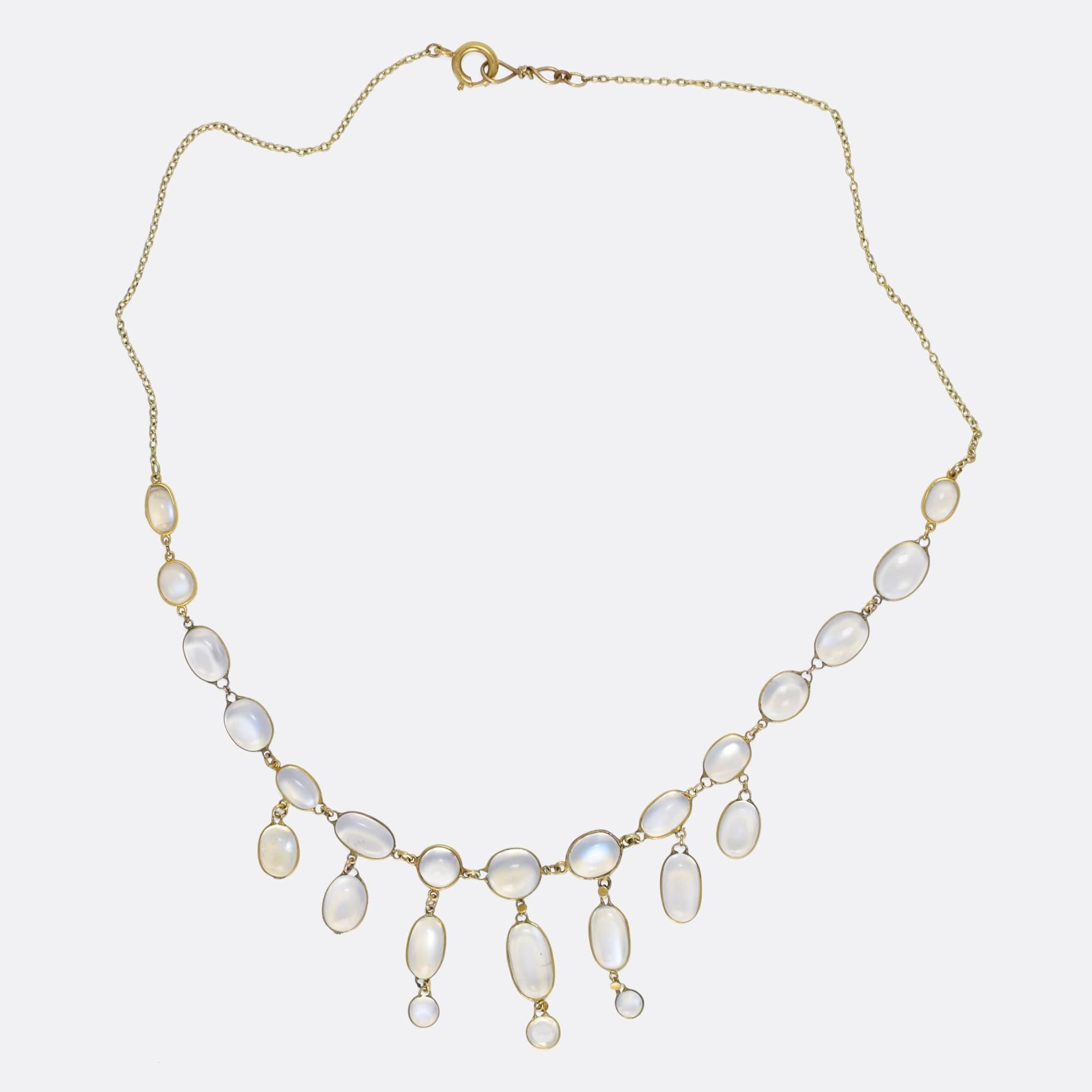 A wonderful blue moonstone festoon necklace, set with 25 cabochon stones in three tiers. The moonstones display strong adularescence - the effect whereby they appear to glow brightly from within - and rest in 15k gold mounts on a fine trace chain.