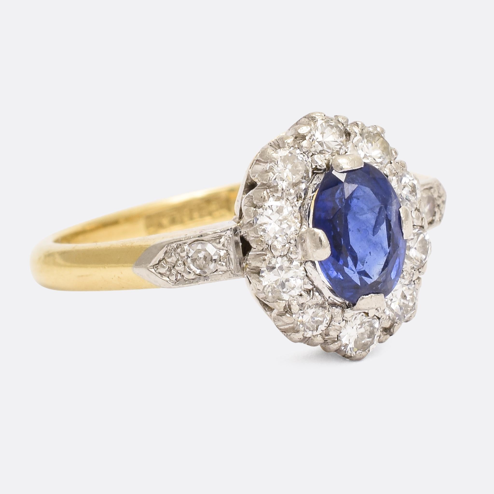 This stunning antique cluster ring dates from the very early 20th Century, circa 1910. It's set with a mouthwatering natural blue sapphire - of exceptional colour - and a halo of brilliant cut diamonds. Modelled in platinum and 18k yellow gold it's