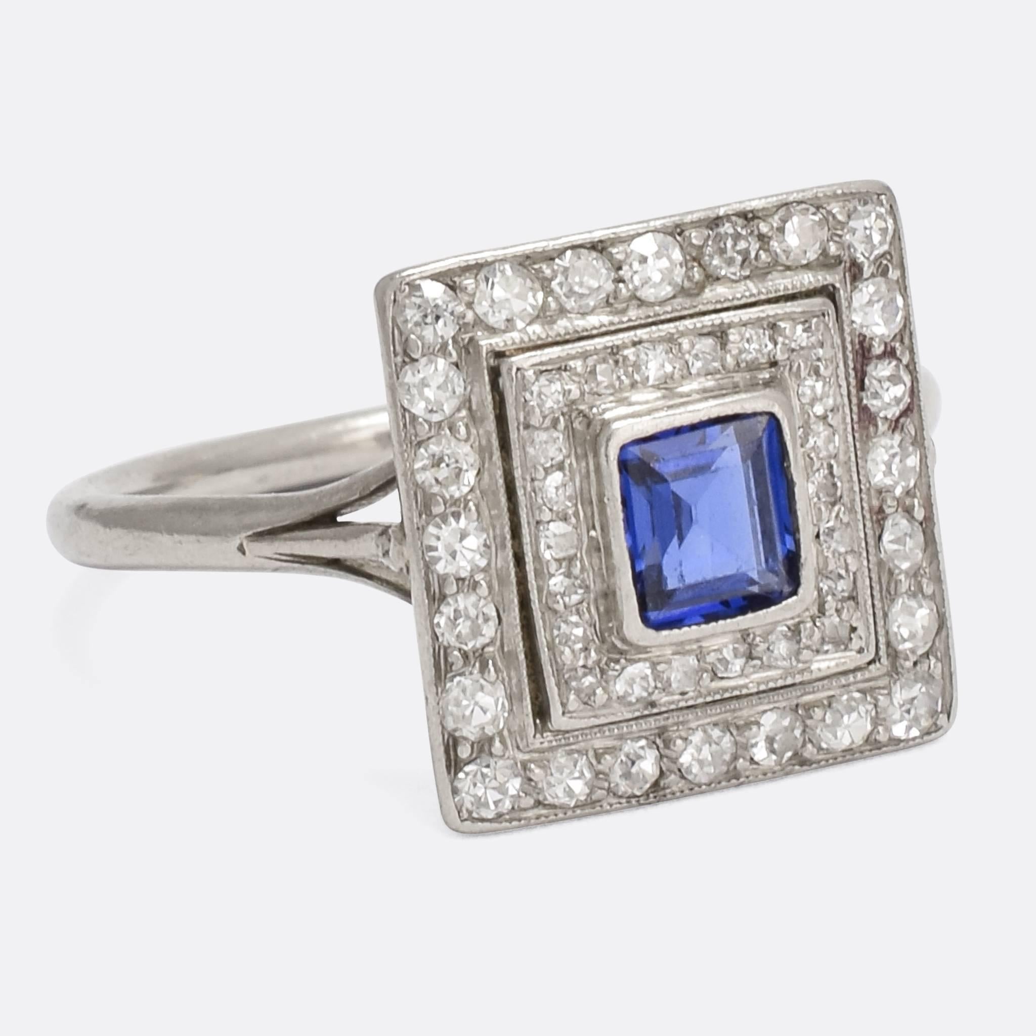 An incredible antique double halo ring, the central blue sapphire is framed by two square halos: each set with old mine cut diamonds and finished in fine millegrain. The head rests on an openworked gallery, allowing light in behind the stones, and