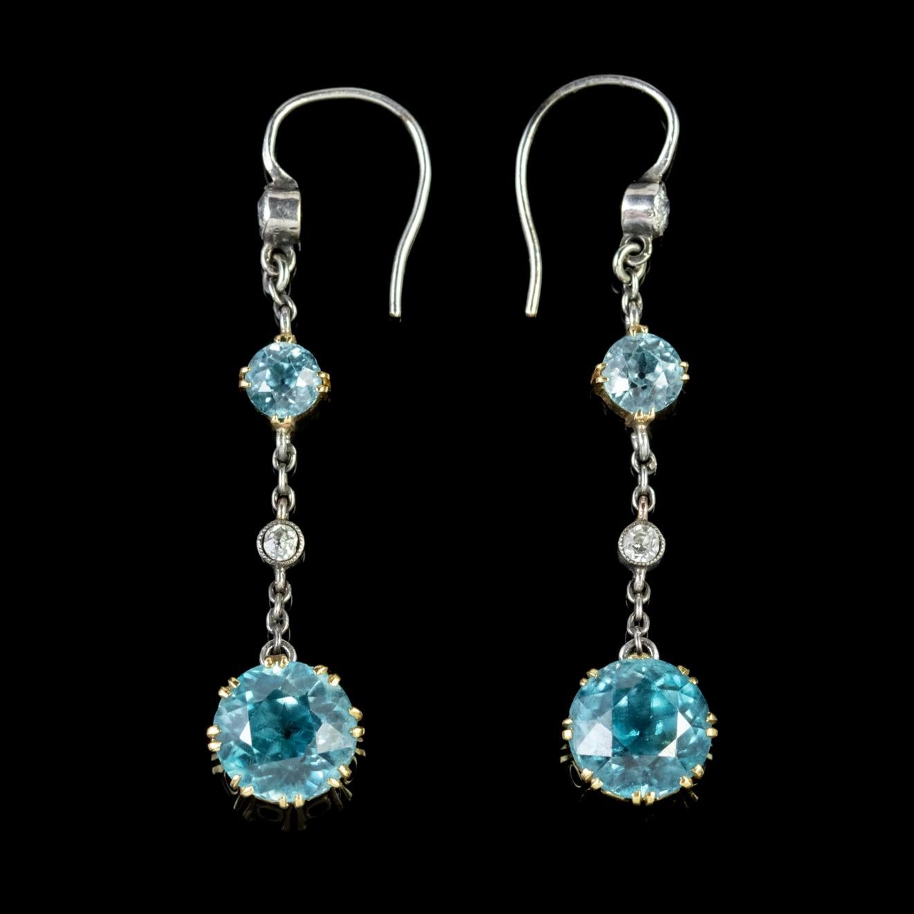 A fabulous pair of antique Edwardian drop earrings adorned with two Diamonds and two Blue Zircons. The largest Zircon is a beautiful 1.70ct stone with a smaller 0.25ct stone sat above. 

Blue Zircon is a lovely shade of teal/ blue and was once said