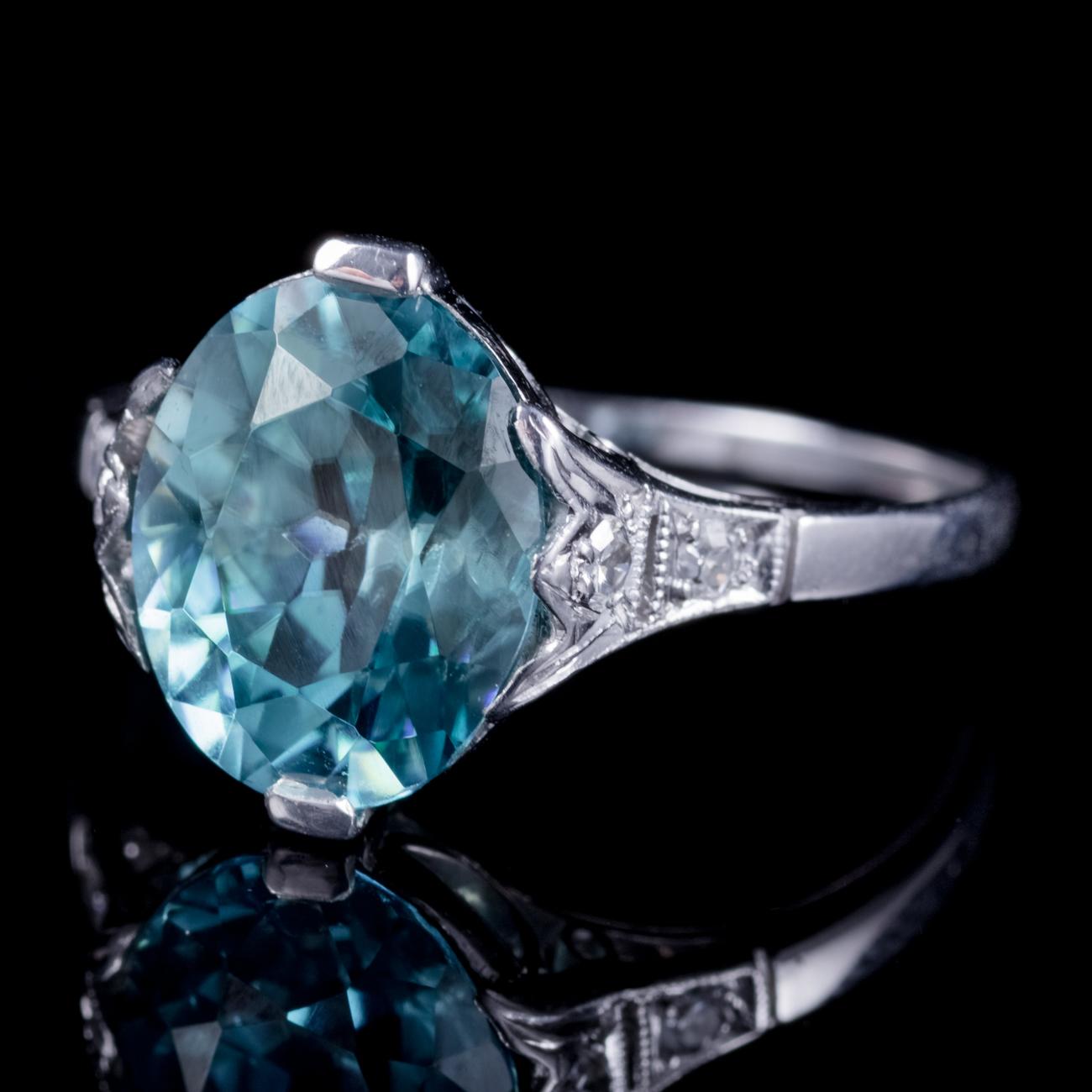 A stunning antique Edwardian ring adorned with a magnificent 4.43ct blue Zircon flanked by two Diamonds down each shoulder. Blue Zircon is a lovely shade of teal/ blue and was once said to bring prosperity and wisdom to its wearer. The stone is set