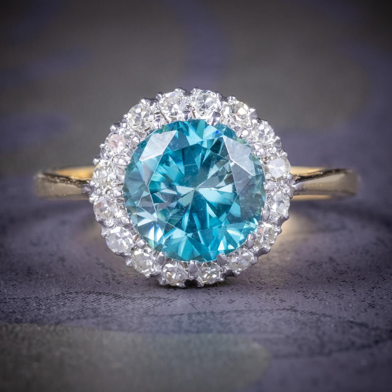 A fabulous antique Edwardian cluster ring C. 1910, adorned with a beautiful 3.21ct blue Zircon surrounded by a halo of old cut Diamonds. 

The old cuts are beautiful SI1 clarity - H colour Diamonds, approx. 0.80ct in total.

The stones are set in a