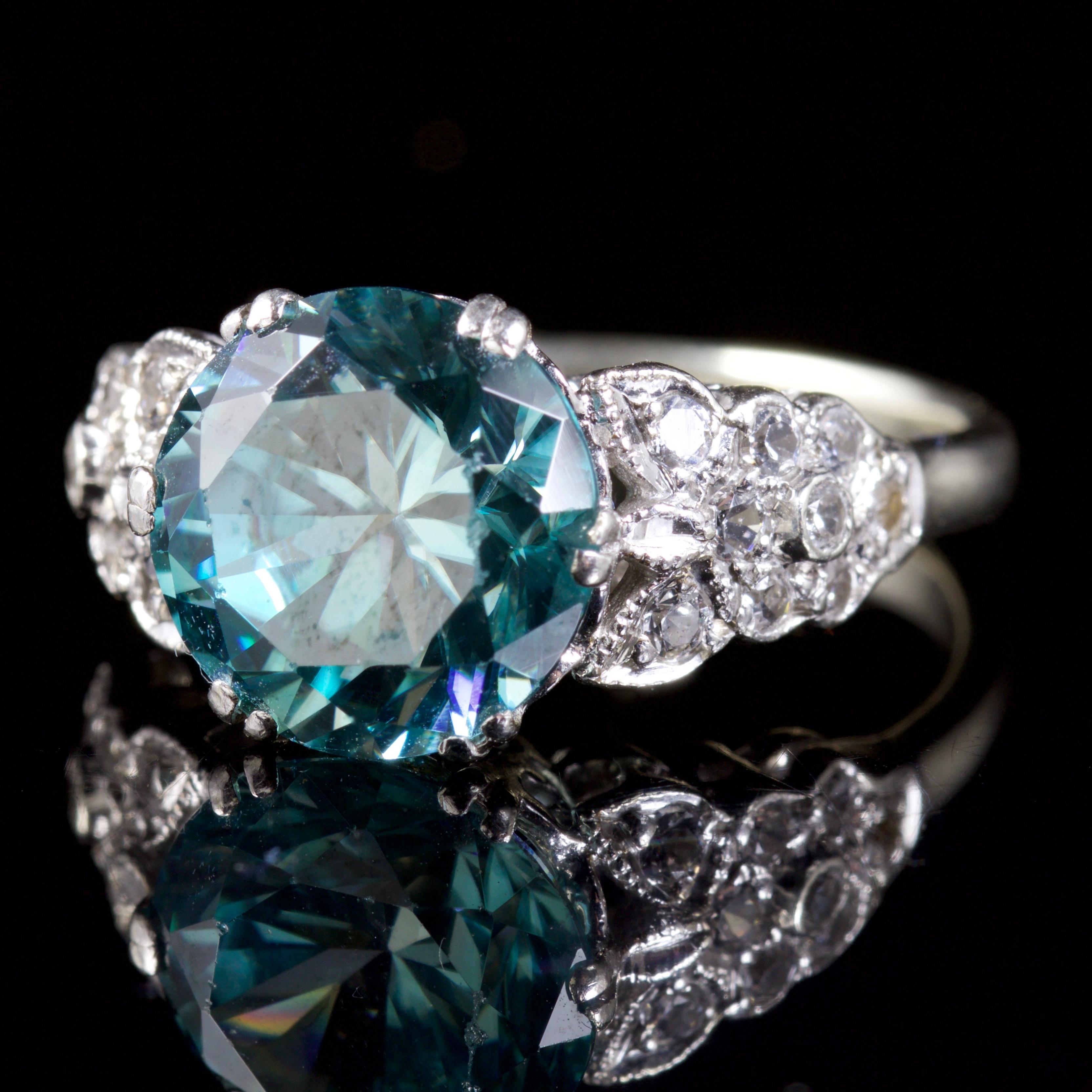 This beautiful Blue Zircon and Spinel ring is Edwardian, Circa 1914.

The ring boasts a 3.5ct Zircon in the centre, with beautiful white Spinels encrusted into both shoulders.

The white Spinels are fantastic, forever sparkling against the White