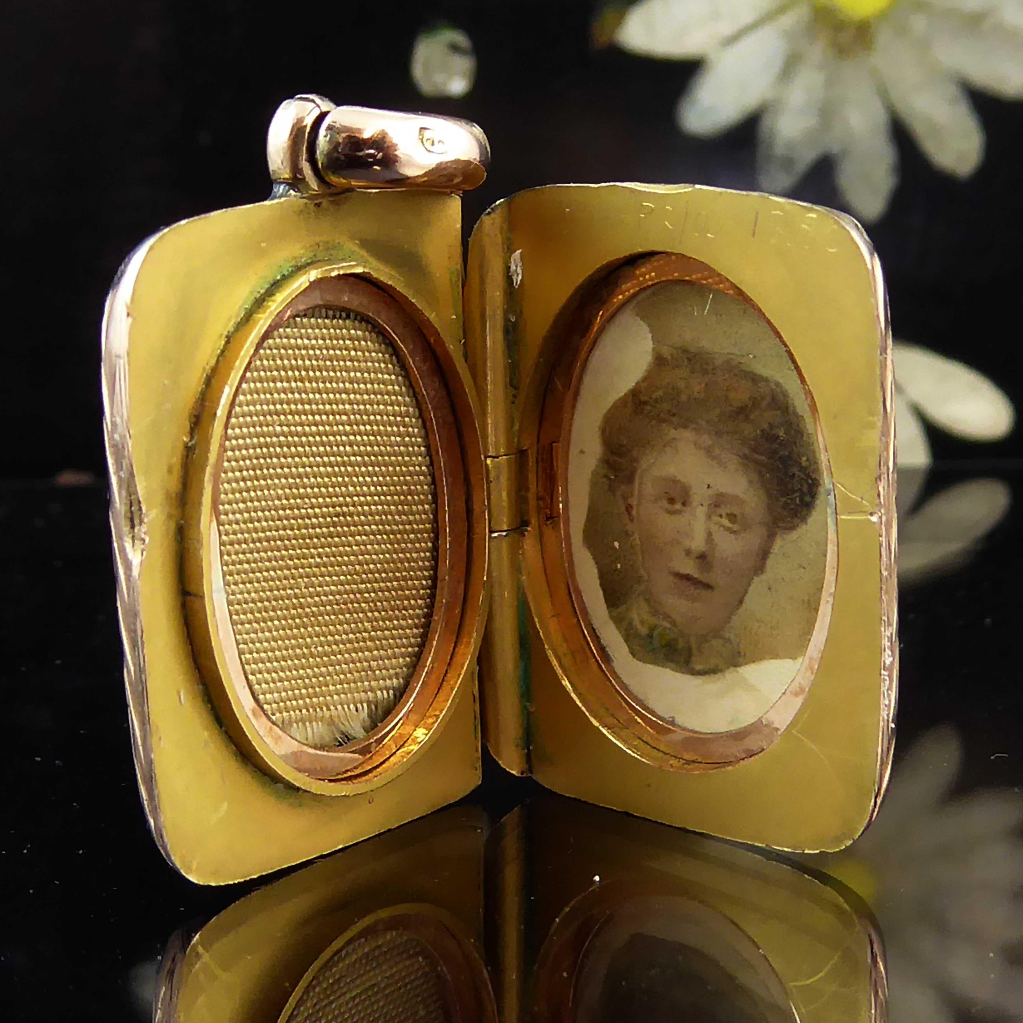 Dating from the Edwardian era, this delightful locket is very neat and petite making it perfect for everyday wear.  Hand engraved to both sides in a floral and scroll work pattern - even the edges of the locket have been engraved with a feathered