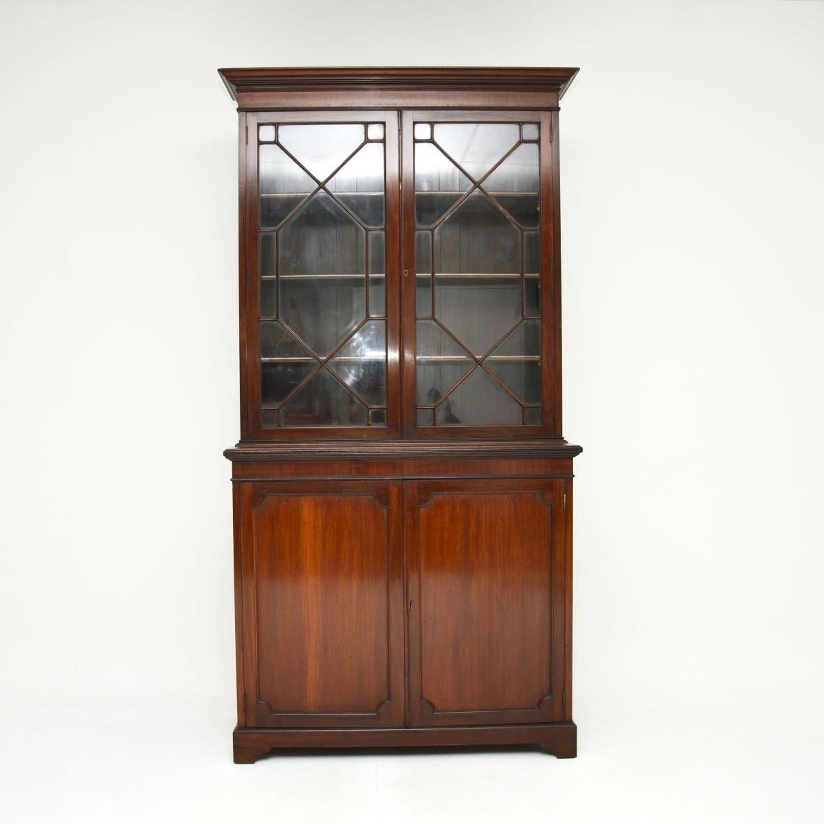 A smart and extremely well made antique Edwardian bookcase. This was made in England, it dates from around 1890-1910.

It is of superb quality, this has a panelled back and refined design. The base has two panelled doors and sits on bracket feet,