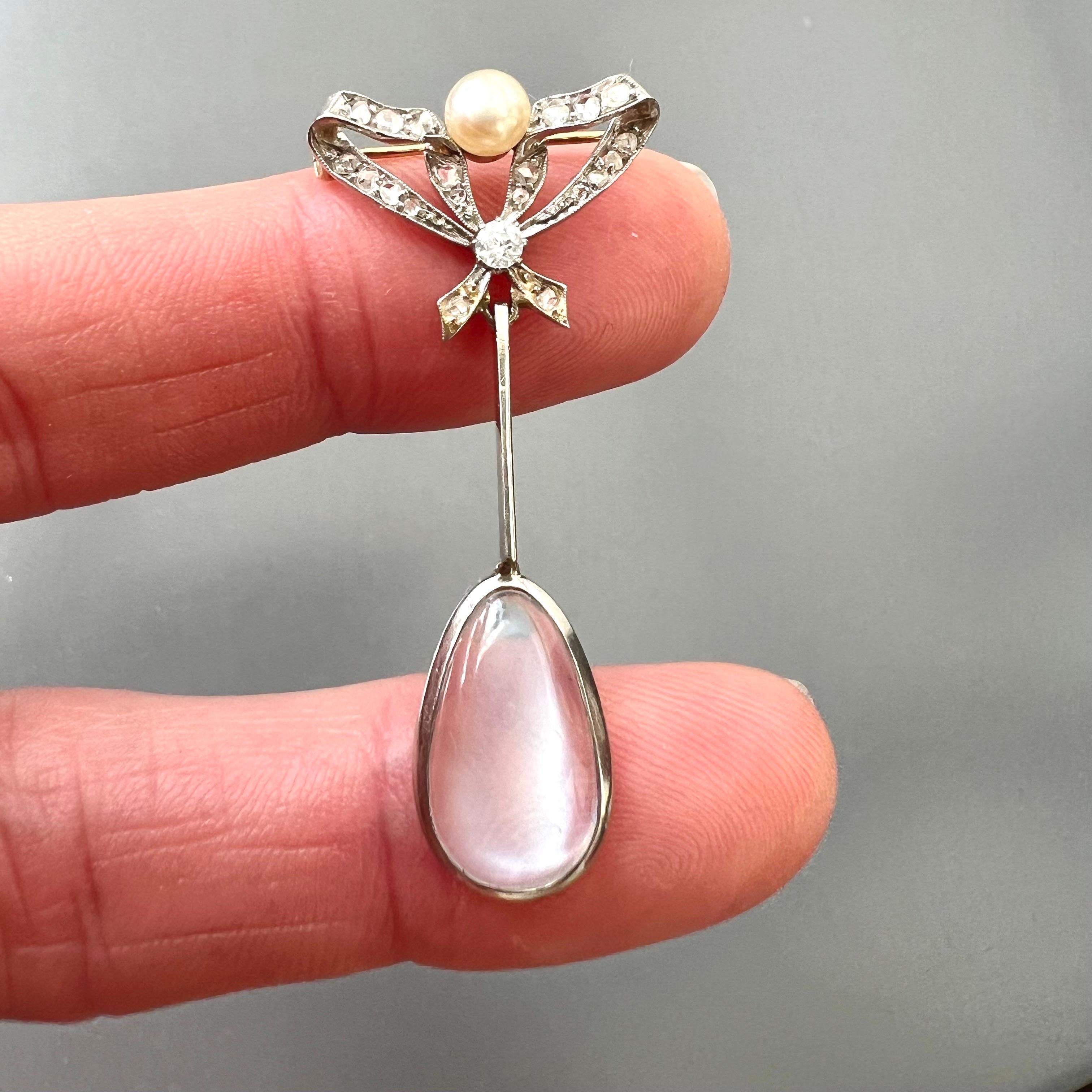 A rare and enchanting example of early 20th-century craftsmanship, this antique brooch has a fine and delicate design with timeless elegance. The top is finely crafted in the shape of a bow, the piece captures the romantic sensibilities typical of