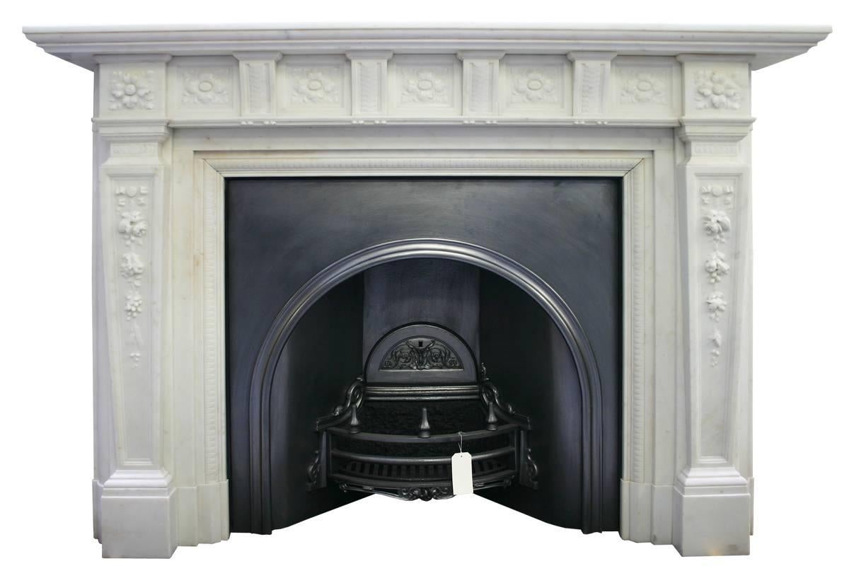 Large finely carved statuary marble fire surround. Tapering jambs with carved ribbons and cascading flowers and fruit support square end blocks with high relief carved flowers. The frieze has five finely carved panels also of flowers separated by