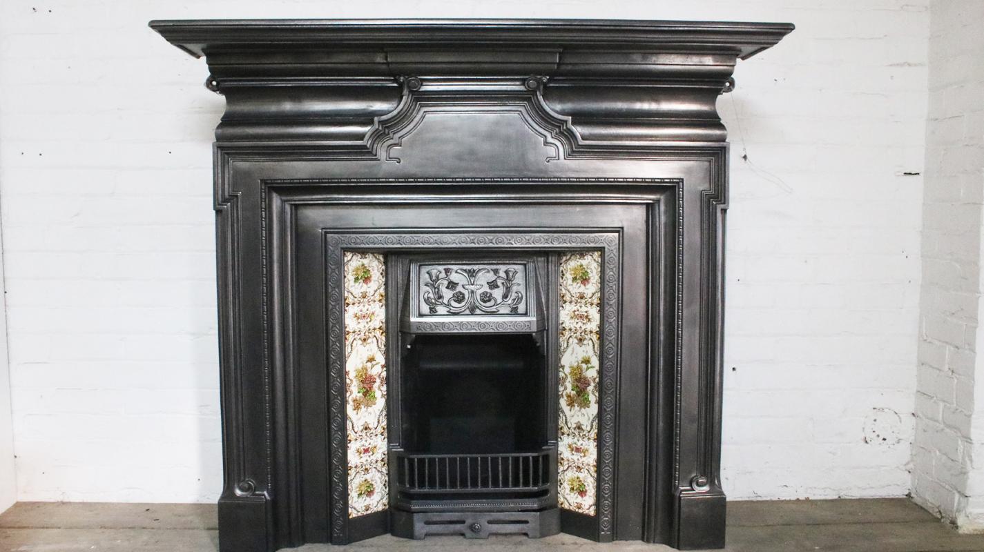 Antique Edwardian cast iron fire surround in the Georgian revival style, the jambs benefiting from a dog leg moulding. 

Finished in traditional black grate polish giving a gun metal sheen. This finish can be changed if required, please contact us
