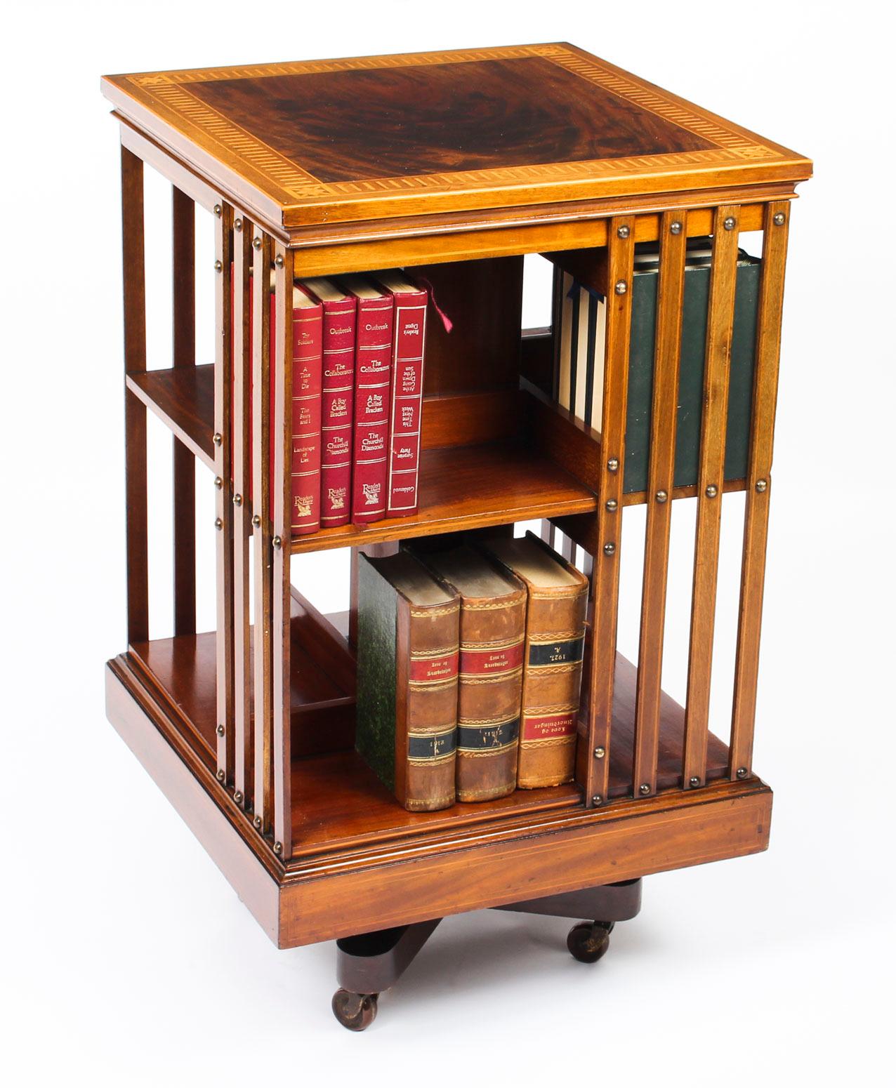 This an exquisite antique revolving bookcase attributed to the renowned retailer and manufacturer Maple & Co., circa 1890 in date.

It is made of mahogany , revolves on a solid cast iron base, the top with flame mahogany and an elaborate chequer