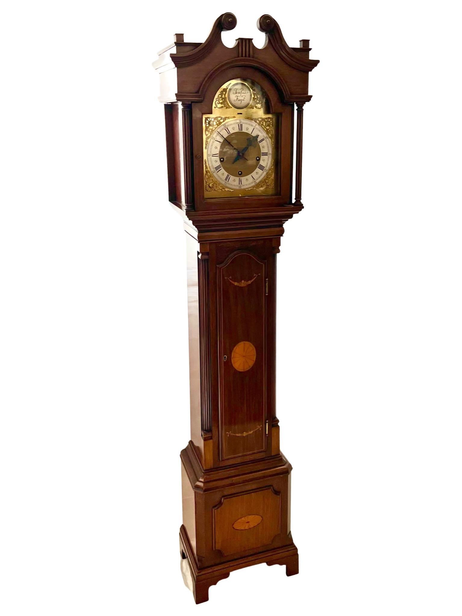 A handsome Edwardian Chippendale style mahogany eight day quarter chiming miniature longcase clock.

The solid mahogany case is a deep rich colour and has a beautiful swan neck pediment with delicate boxwood inlay decorations, in keeping with the