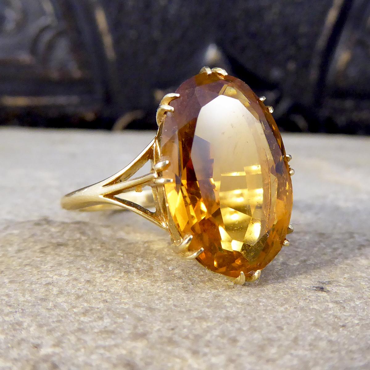 Looking for a beautiful antique ring? This one holds colourful Citrene, held securely into place with many 18ct yellow Gold claws. Connecting the 18ct yellow Gold band and the head of this ring is three threads of 18ct Yellow Gold on either