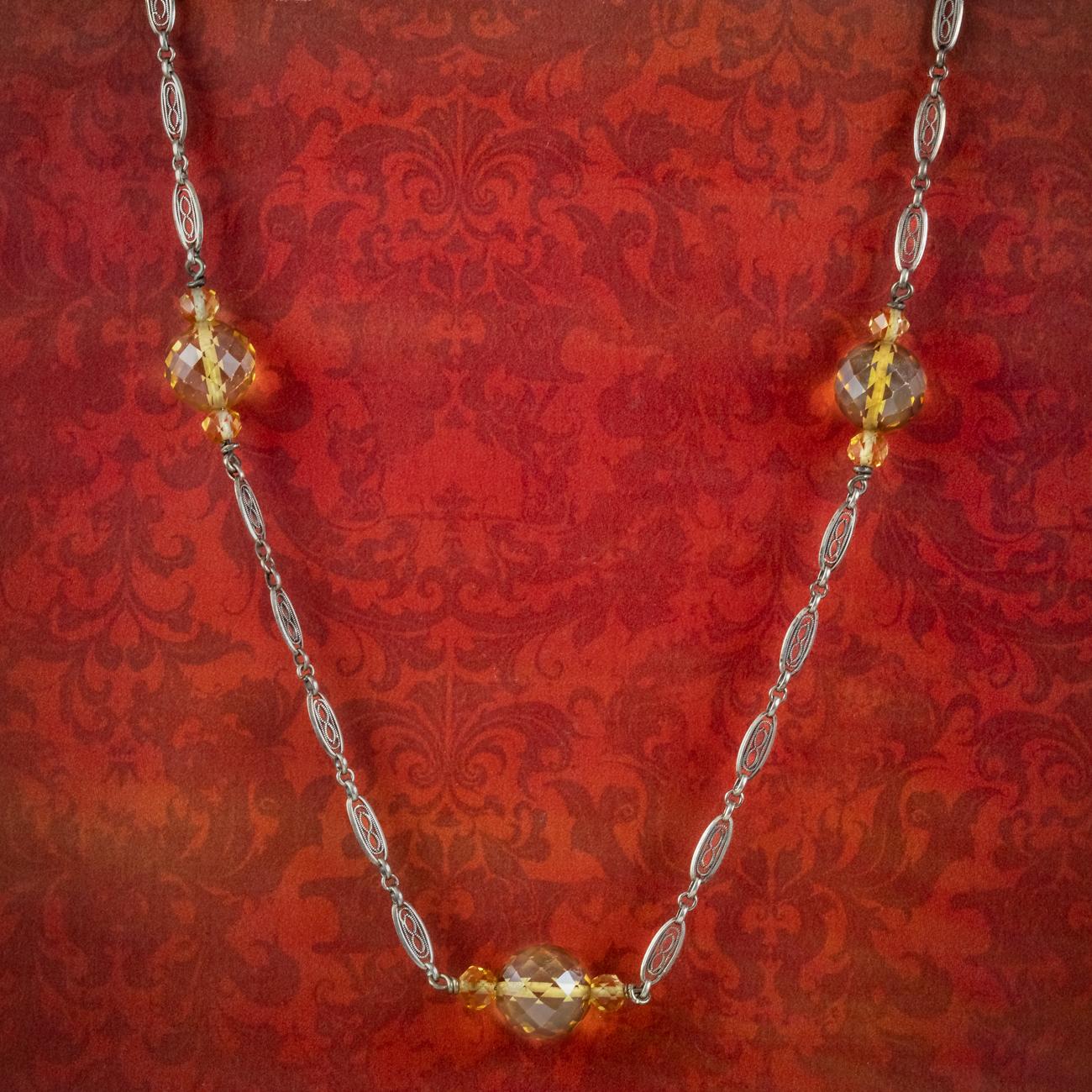 A marvellous antique Edwardian chain adorned with five large briolette cut citrine beads with smaller citrines set on either side. They have been cut with an array of diamond-shaped facets that glisten beautifully when they catch the light and
