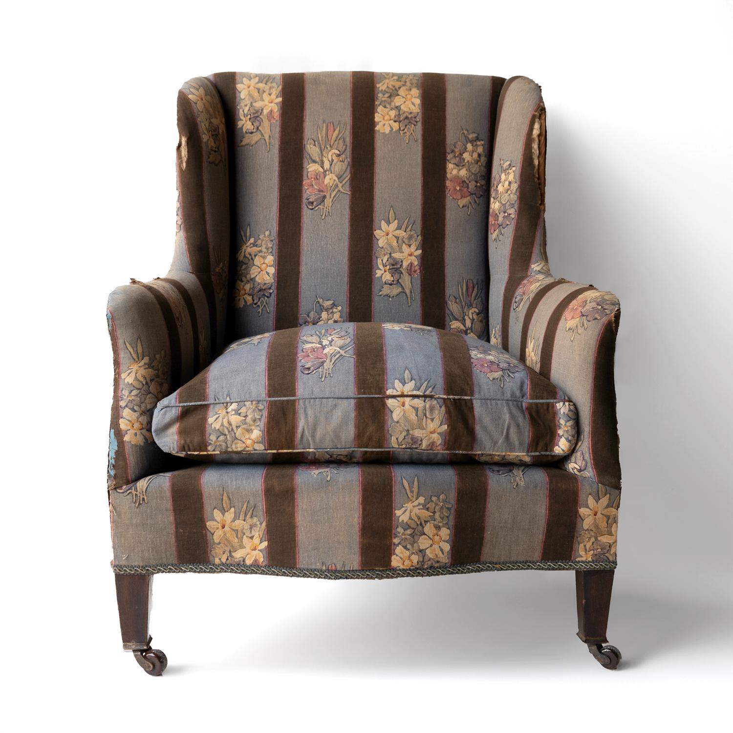 ANTIQUE UPHOLSTERED CHAIR 
A good quality country house chair of fairly squat proportions currently in its original and wonderful stripy blue floral fabric with depictions of crocuses, daffodils and snowdrops.

Standing on tapered wooden legs with