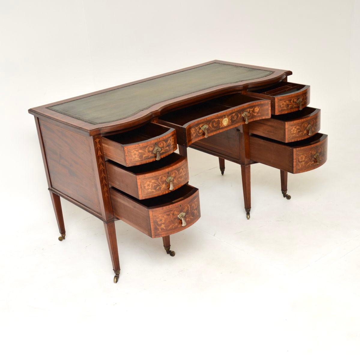 A beautiful antique Edwardian desk by Edwards and Roberts. It was made in England, it dates from the 1900-1910 period.

This is of outstanding quality, it is extremely well made and is a lovely size. The wood has profuse floral inlays of satinwood