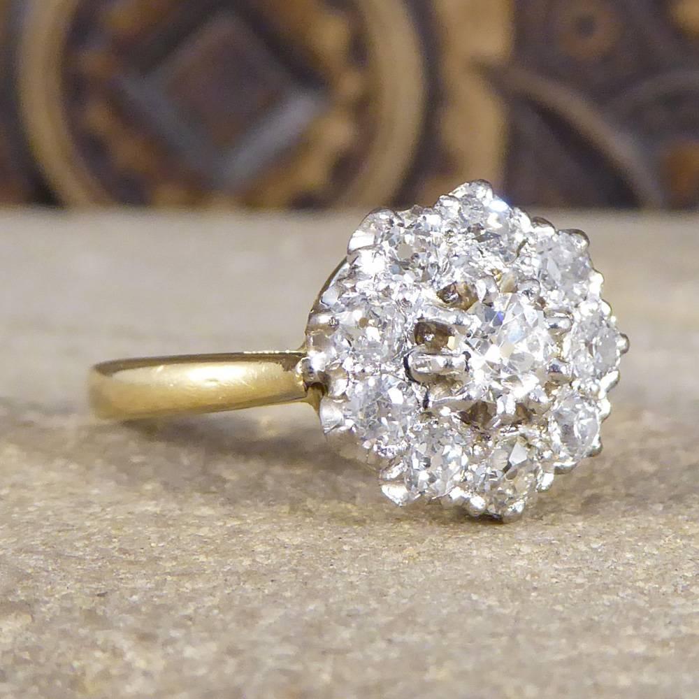 This stunning and sparkly ring features an Old Cut Diamond in the centre surrounded by 9 Old Cut Diamonds weighing 0.70cts in total. These Diamonds are complimented by the Platinum claw setting leading to an 18ct yellow gold band. This ring has been
