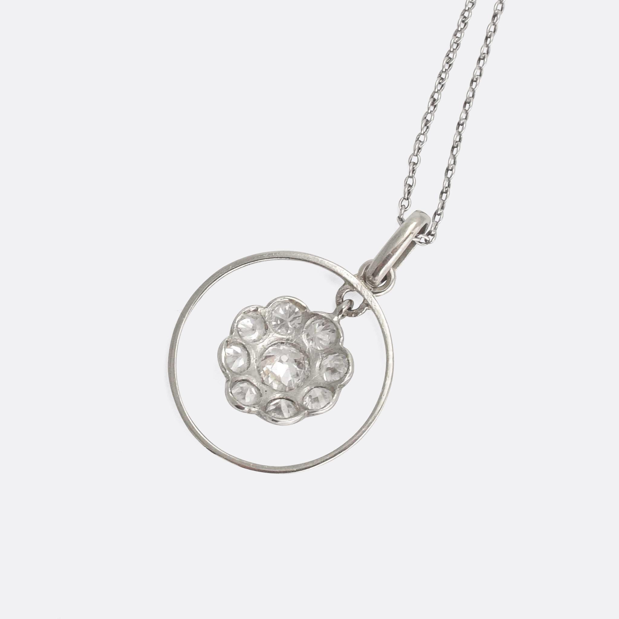 A beautiful and understated Edwardian necklace. The pendant is modelled as a daisy, fully set with diamonds, and dangling within a platinum halo. Offered with a 15k white gold trace chain, it epitomises the refinement of the Edwardian era.

STONES
