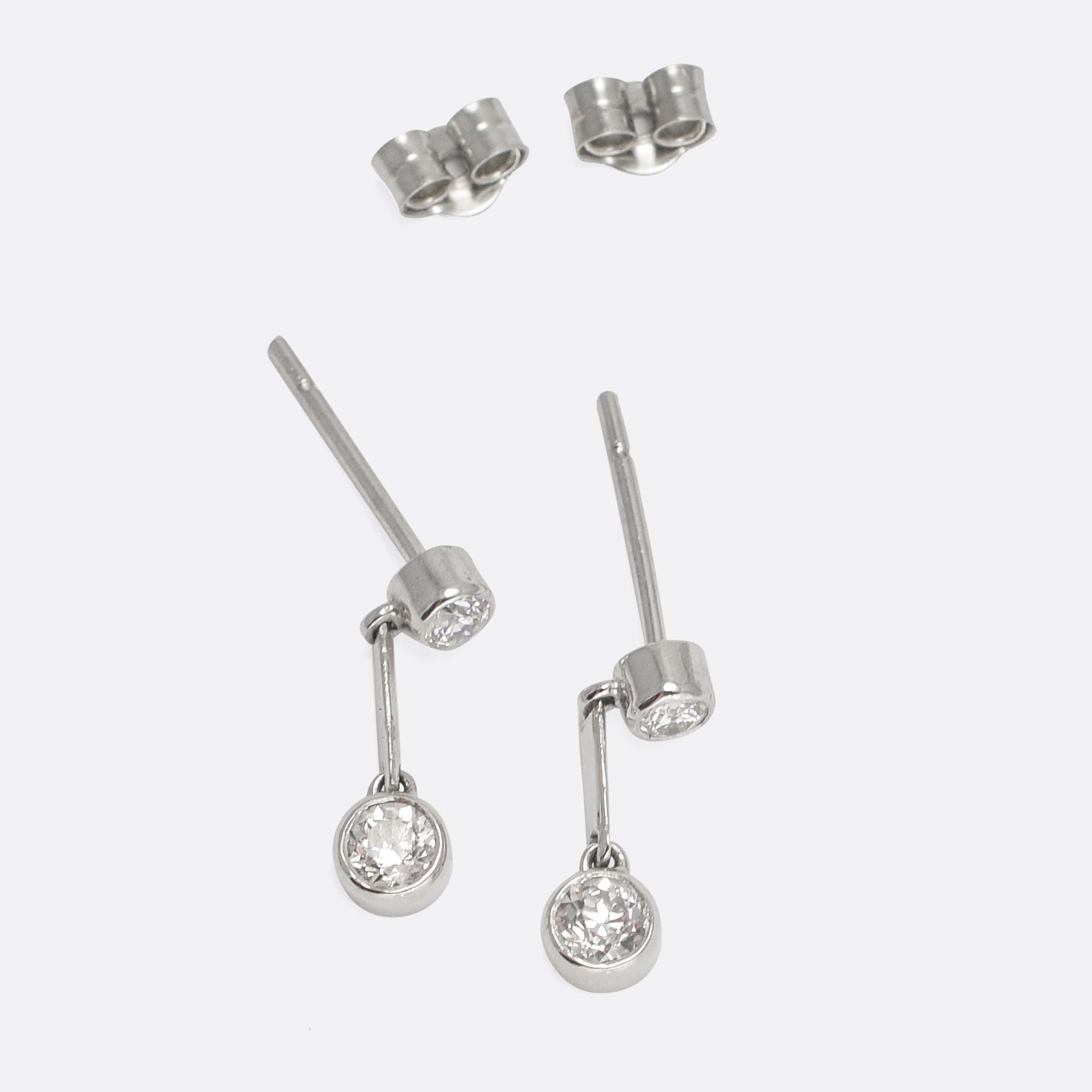 A pretty pair of diamond stud earrings; each one set with two old cut stones separated by an articulated platinum bar. They epitomise Edwardian styling: refined and subtle, but with an undeniable and eye-catching beauty. Rare and perfectly