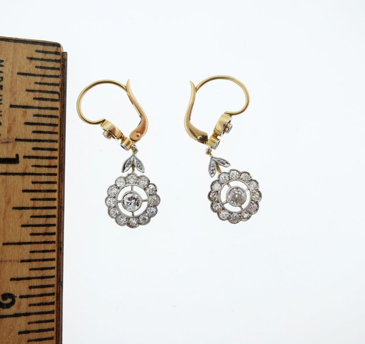  Pretty platinum top gold back diamond top earrings, each French back earring measures approx 1.25 inches in length and is set with a cluster of 15 mill grained edge  old mine and single cut diamonds. Total diamond weight approx 1.1 cts. Circa 1910.