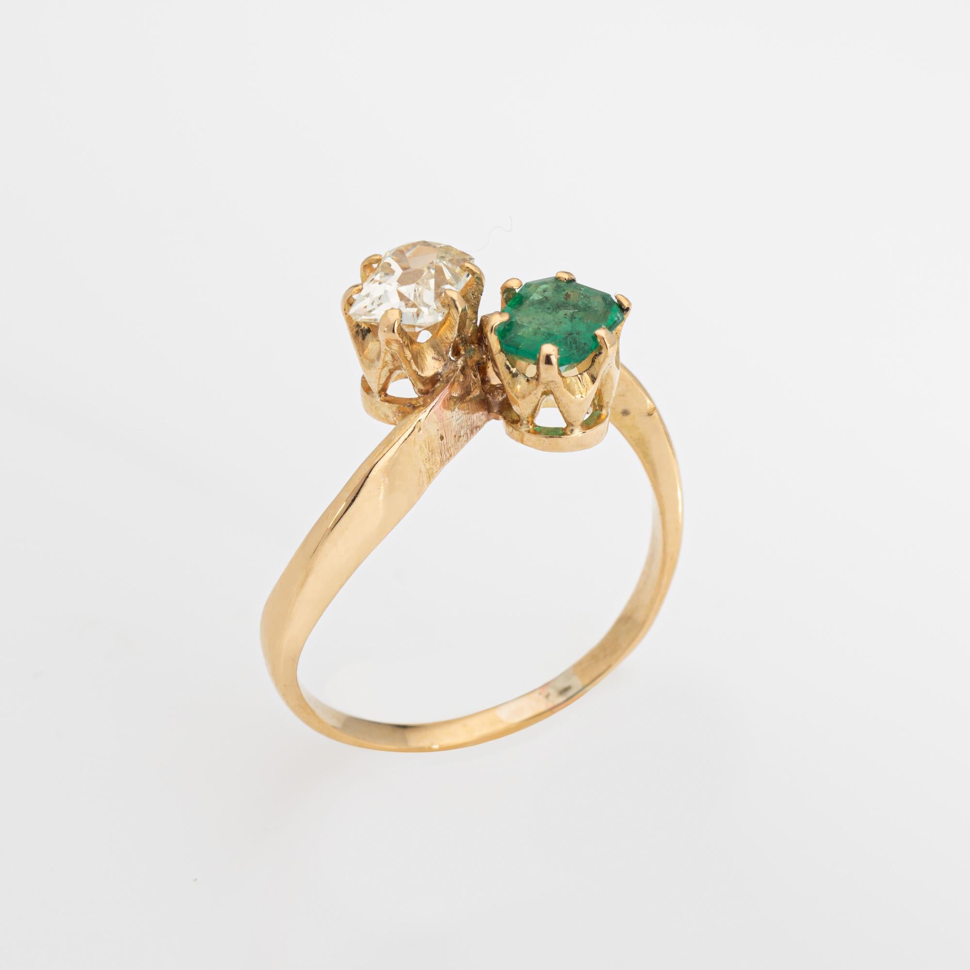 Finely detailed antique Edwardian diamond & emerald 'moi et toi' ring crafted in 18k yellow gold (circa 1910s to 1920s).  

Old mine cut diamond is estimated at 0.60 carats (estimated at L-M color and I1 clarity (note: small chip to the diamond
