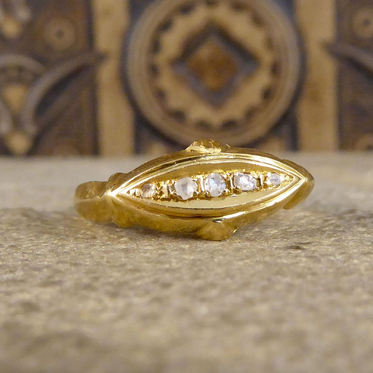 Such a lovely little antique ring that has been hand crafted in the Edwardian era with clear hallmarks on the inner band showing it was made in Birmingham 1912 from 18ct Yellow Gold. The ring has five small Rose Cut Diamonds in a navette shaped face
