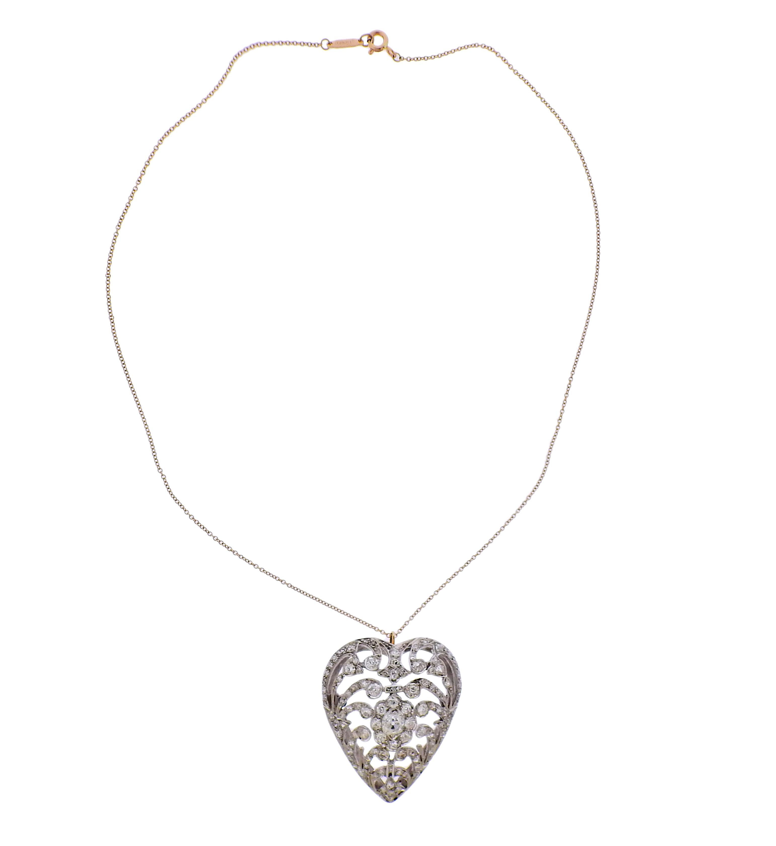 Edwardian 14k gold heart pendant, adorned with approx. 2.20ctw in diamonds (one tiny stone is missing), suspended on a Tiffany & Co 18k gold chain. Pendant measures 37mm x 32mm. Necklace is 16