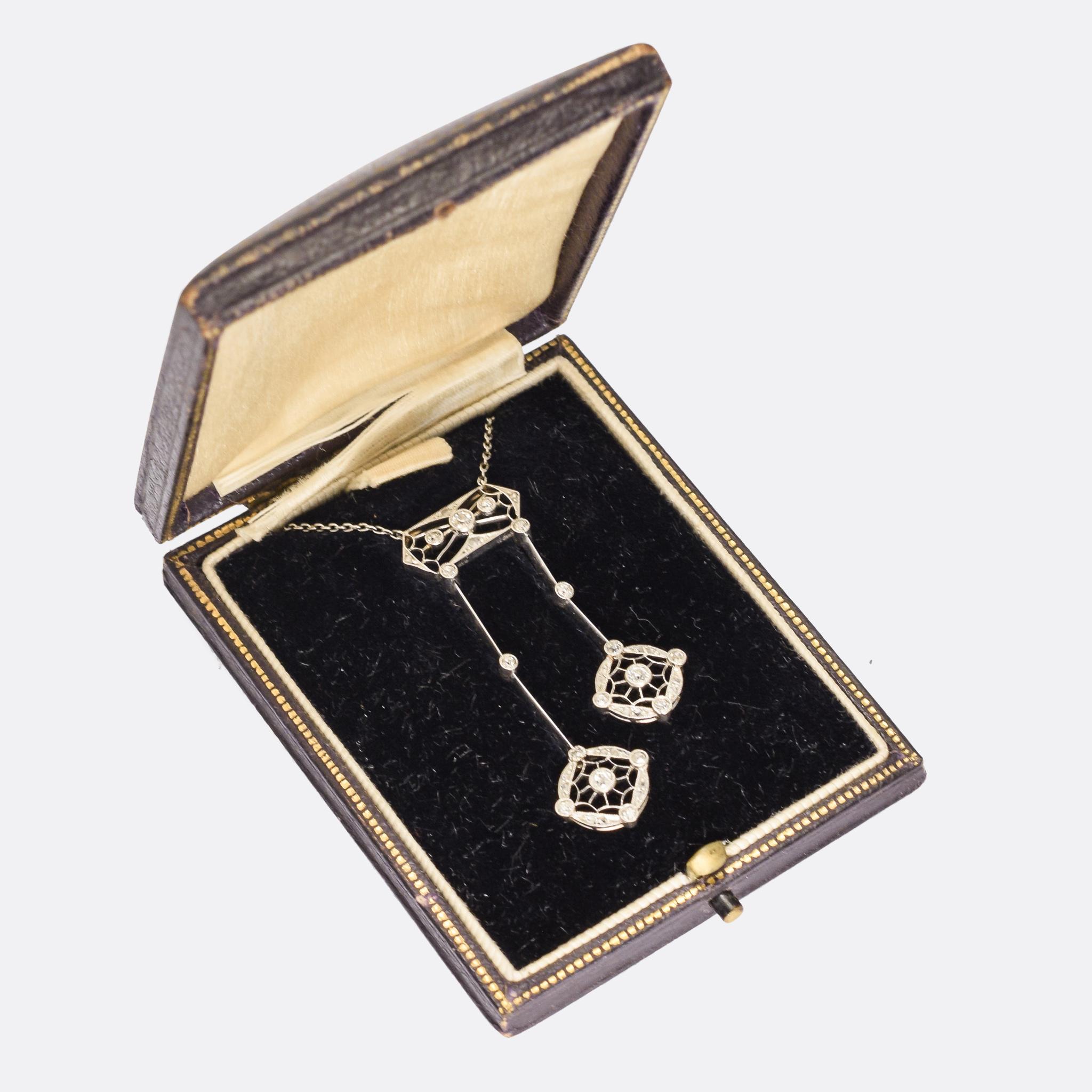 A sublime Edwardian era Negligee Pendant dating from the early 20th Century, circa 1910. It's very finely worked, in platinum throughout, and features a masterclass in openwork and millegrain. Each drop ends with a round, diamond-set, feature with a