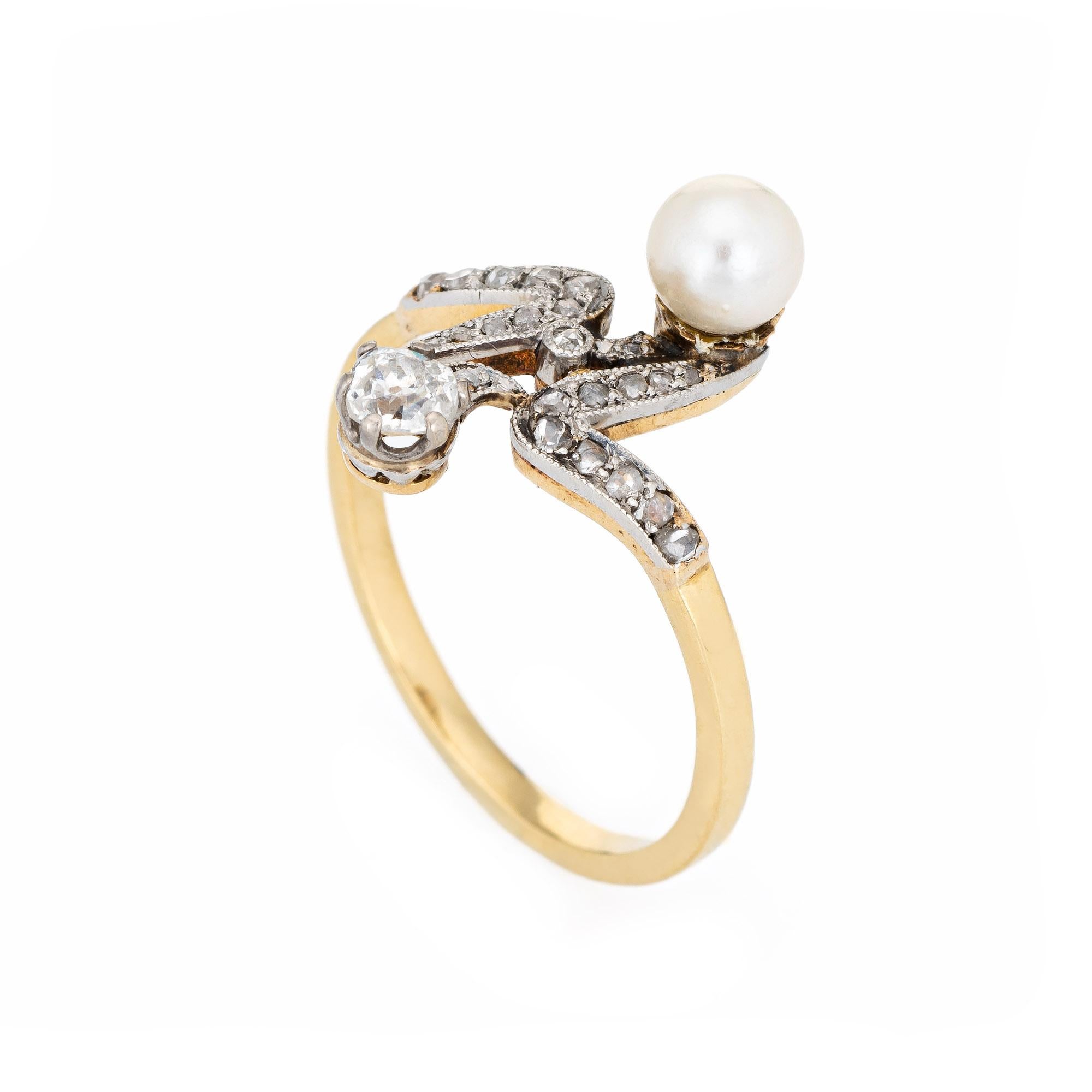 Finely detailed antique Edwardian diamond & pearl 'moi et toi' ring crafted in 18k yellow gold (circa 1910s).  

The old cushion cut diamond is estimated at 0.25 carats, accented with a further 23 estimated 0.01 carat rose cut diamonds. The total