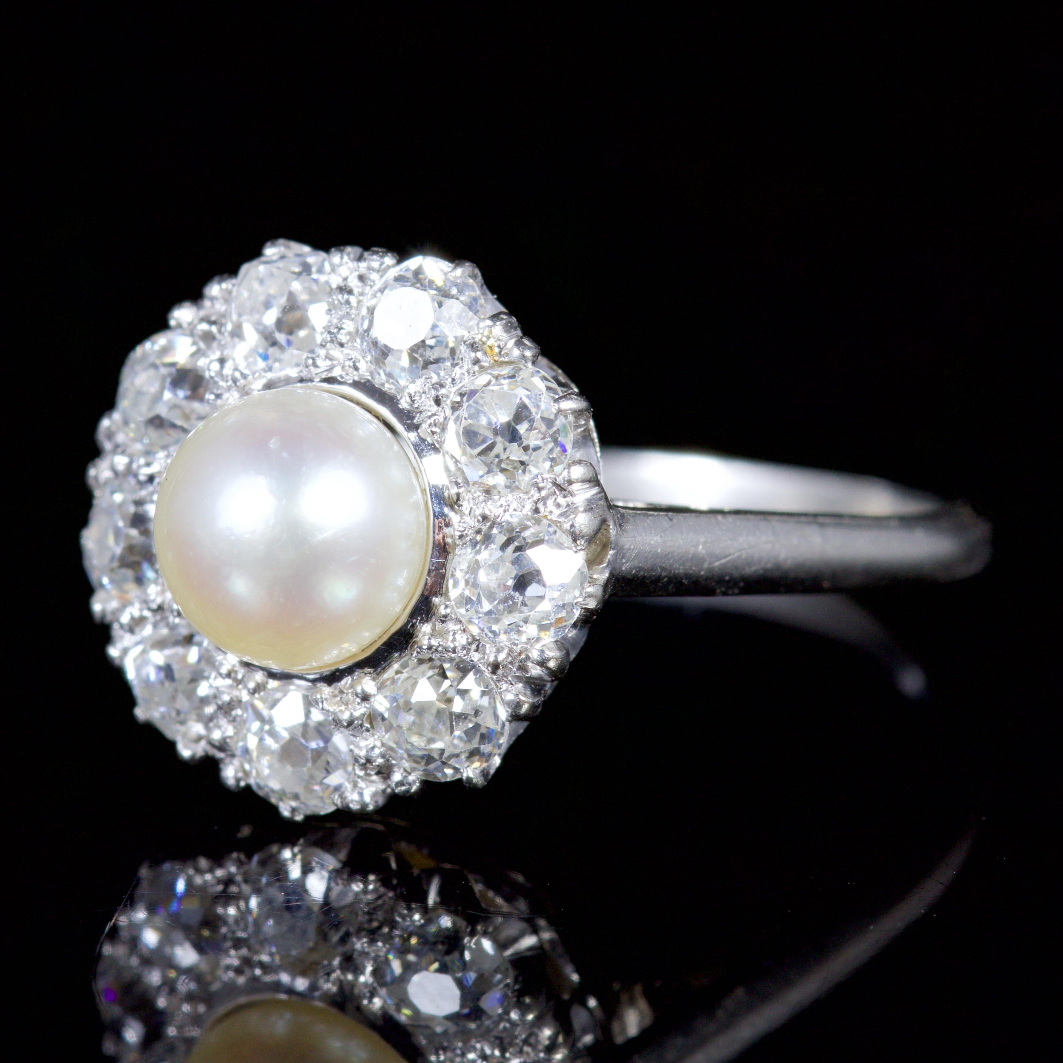 This outstanding Edwardian all platinum Diamond and Pearl ring is Circa 1915.

The elegant ring is beautifully designed, with a rich creamy Pearl in the centre and a halo of glistening Diamonds surrounding it.

It is set with over 1ct of Diamonds