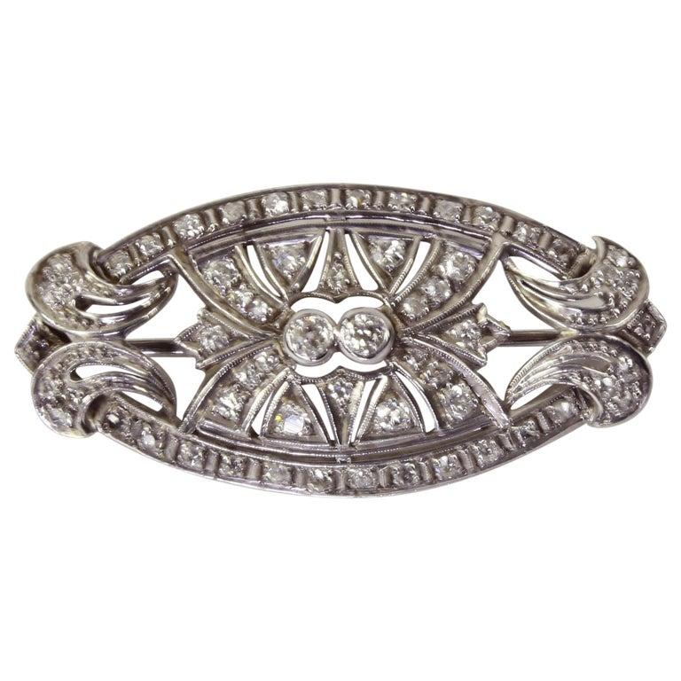 Beautifully hand crafted Platinum Diamond Brooch/Pendant combines classic Edwardian style with the symmetry of Art Deco. Set with approx. 58 Old European cut diamonds. So versatile and well made…can be worn as a pin or pendant. Measures