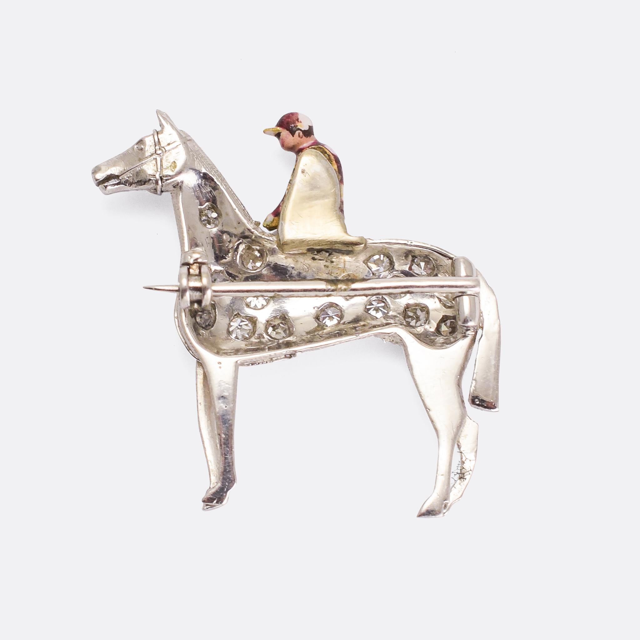 A stunning antique equestrian brooch modelled as a horse and jockey. It's platinum throughout, and set with eight-cut diamonds with the rider finished in purple and white polka-dot enamel. The quality is exceptionally good, with a high level of