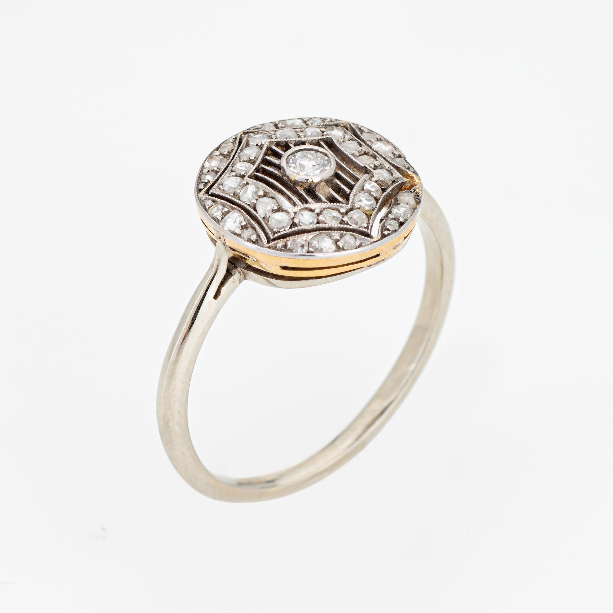 Stylish antique Edwardian diamond crafted in 18k gold & 900 platinum (circa 1910s). 

Center set old European cut diamond is estimated at 0.10 carats (estimated at I-J color and SI1-2 clarity). Old rose cut diamonds surround the center diamond and
