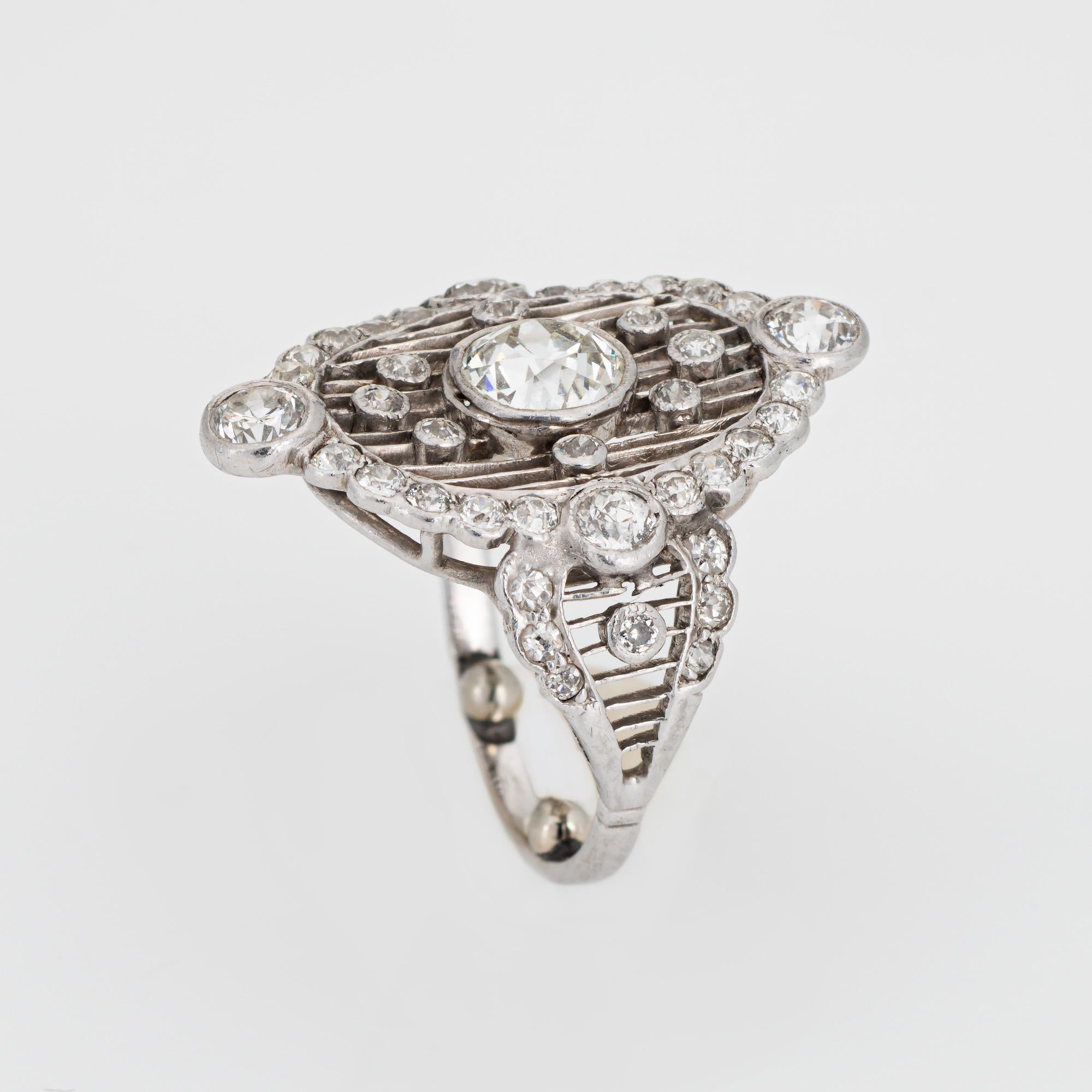 Stylish antique Edwardian diamond crafted in 900 platinum (circa 1910s). 

Center set old European cut diamond is estimated at 0.75 carats (estimated at I-J color and VS2 clarity). Old European cut diamonds surround the center diamond and total an