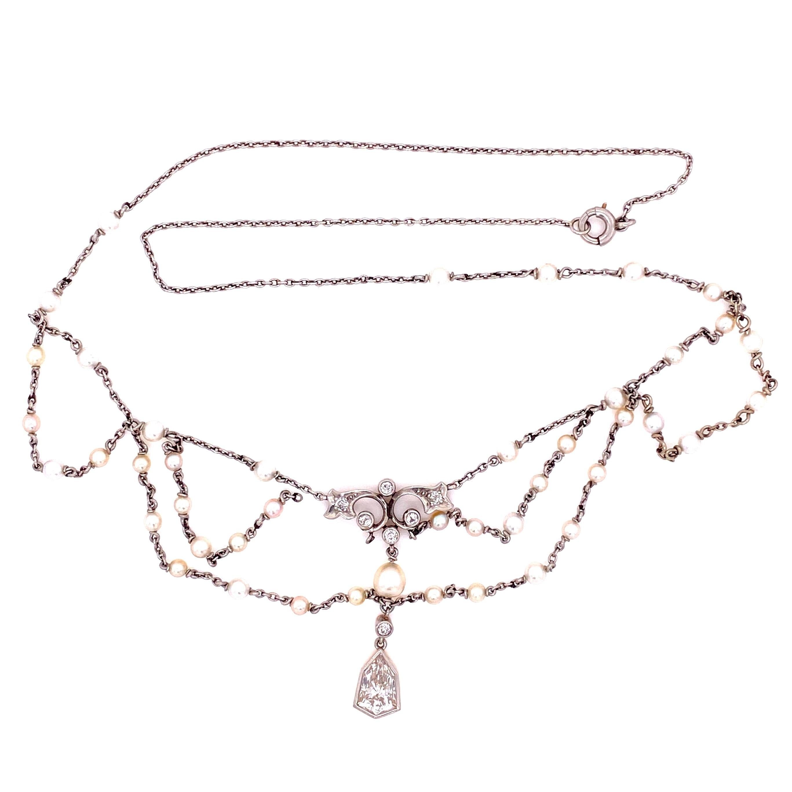 Simply Beautiful! Outstanding Edwardian Diamond and Seed Pearl Platinum Swag Bib Necklace, linking 18K Gold chain inter-spaced with Seed Pearls. Center accented by Hand set Diamonds, approx. 1.50tcw and exhibiting a pendant with a Shield cut Diamond