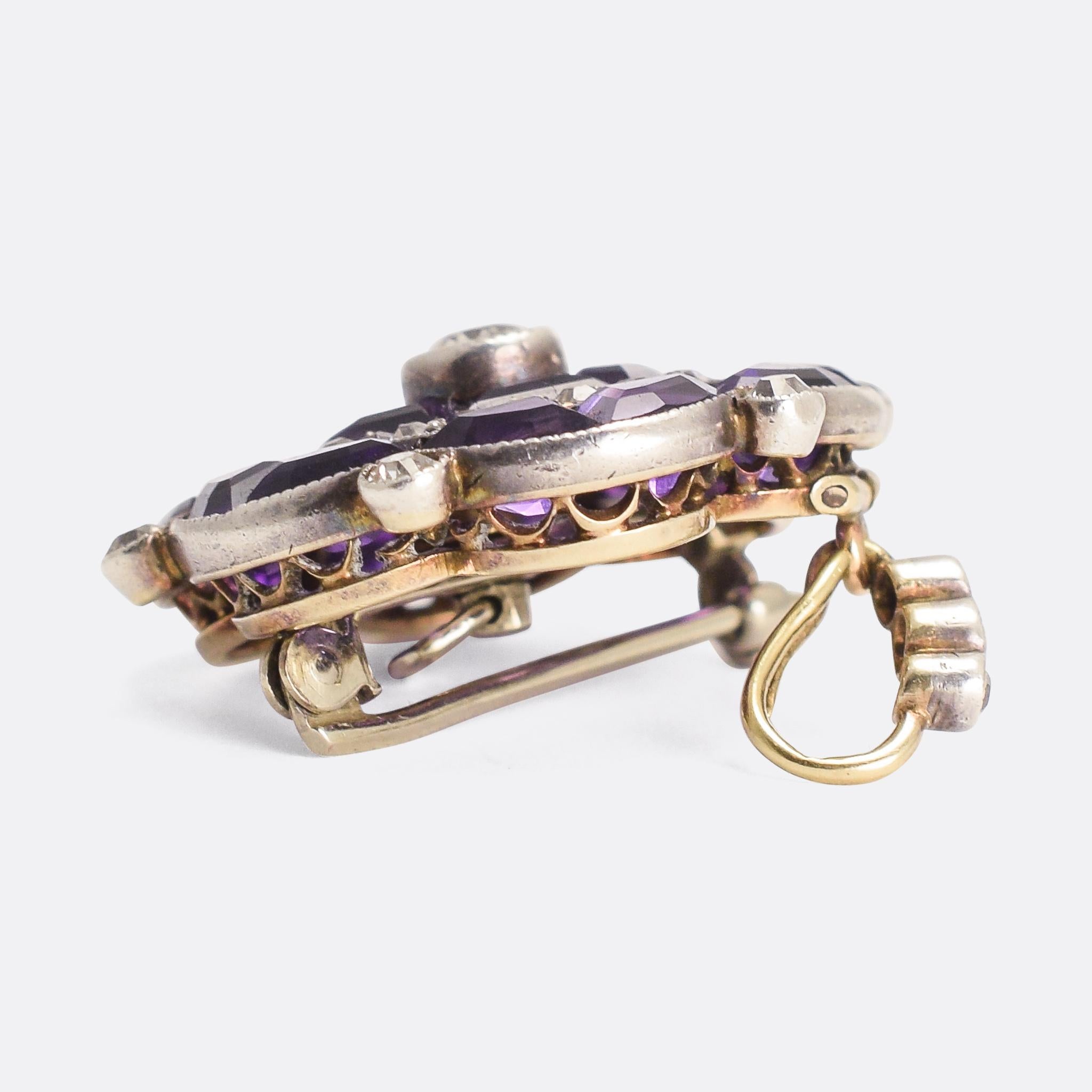 A stunning antique pendant dating from the Edwardian period, circa 1910. It features bezel set old cut diamonds, as well as vibrant invisibly set amethysts. Modelled in 15k gold and platinum, it's exceptionally well made with millegrain detailing