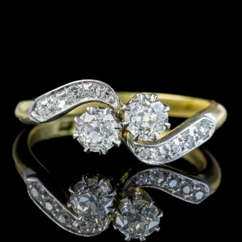 An elegant antique Edwardian “Toi Et Moi” ring adorned with twin old European cut diamonds in the centre with smaller diamonds chasing down each shoulder (approx. 0.66ct total). The centre stones weigh approx. 0.23ct each and are full of life and