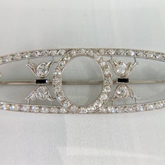 Broche eduardiano de platino de Dreicer & Co. con diamantes y ónix