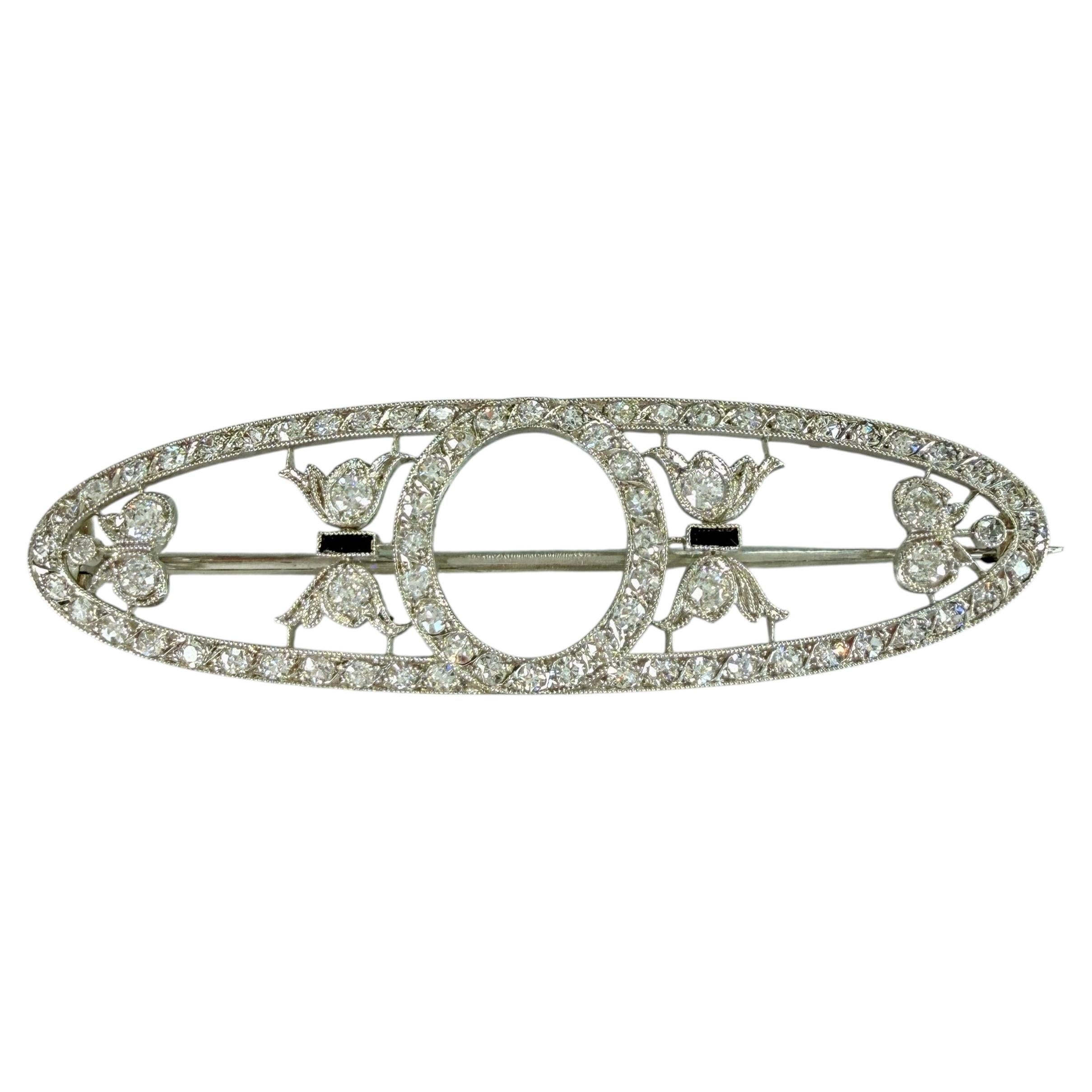 Broche édouardienne en platine signée Dreicer & Co., sertie de diamants et d'onyx