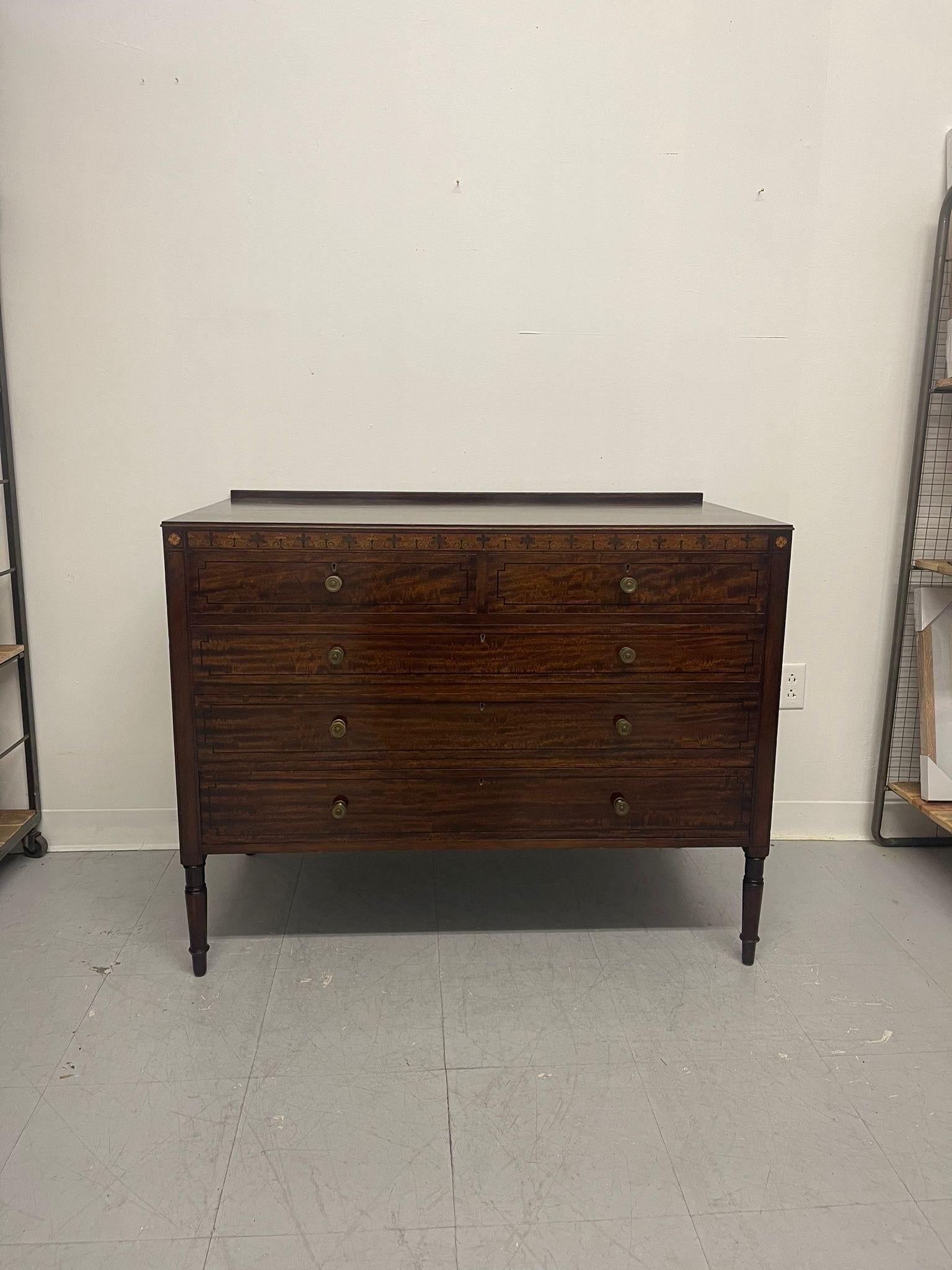 This Antique Dresser has Original Hardware and Dovetailed Drawers. Turned Would Legs, the Wood on this Piece is possibly Mahogany. Finished Back and Interiors to the Drawers as Pictured. Nice Grain to the Wood. Intricate Wood Inlay Feature Appears