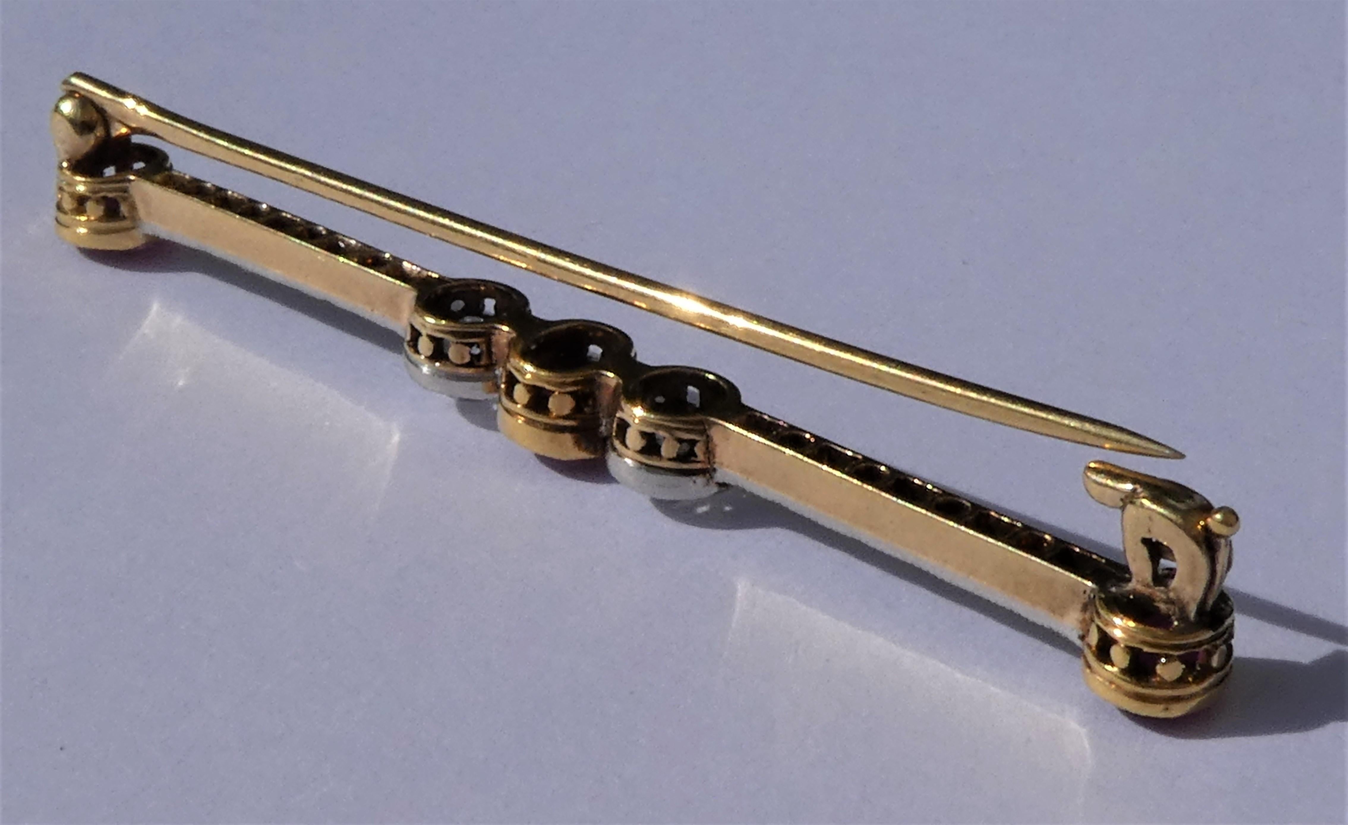 The gorgous long bar pin was handcrafted circa 1910 in the Netherlands in 18 karat rose gold. The diamonds are set in platinum which is typical for that period. Three natural red rubies of circa 1.2 carat in vibrant red colour and 20 diamonds are in