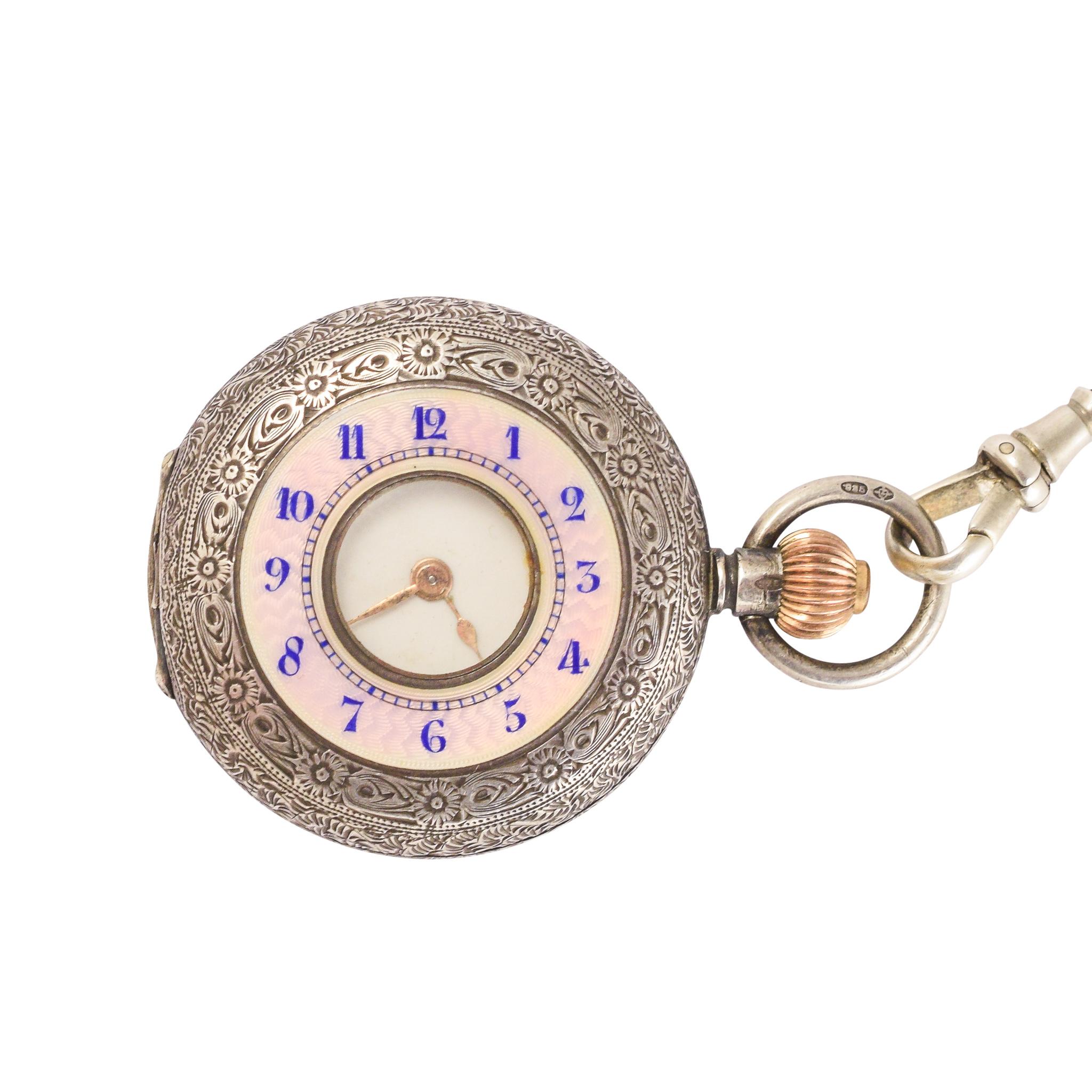 A cute half hunter pocket watch and albertina chain dating from the early 20th Century, circa 1919. The front features beautiful pink guilloché enameling with blue numbers and, of course, a small window to tell the time when it's closed. Both the