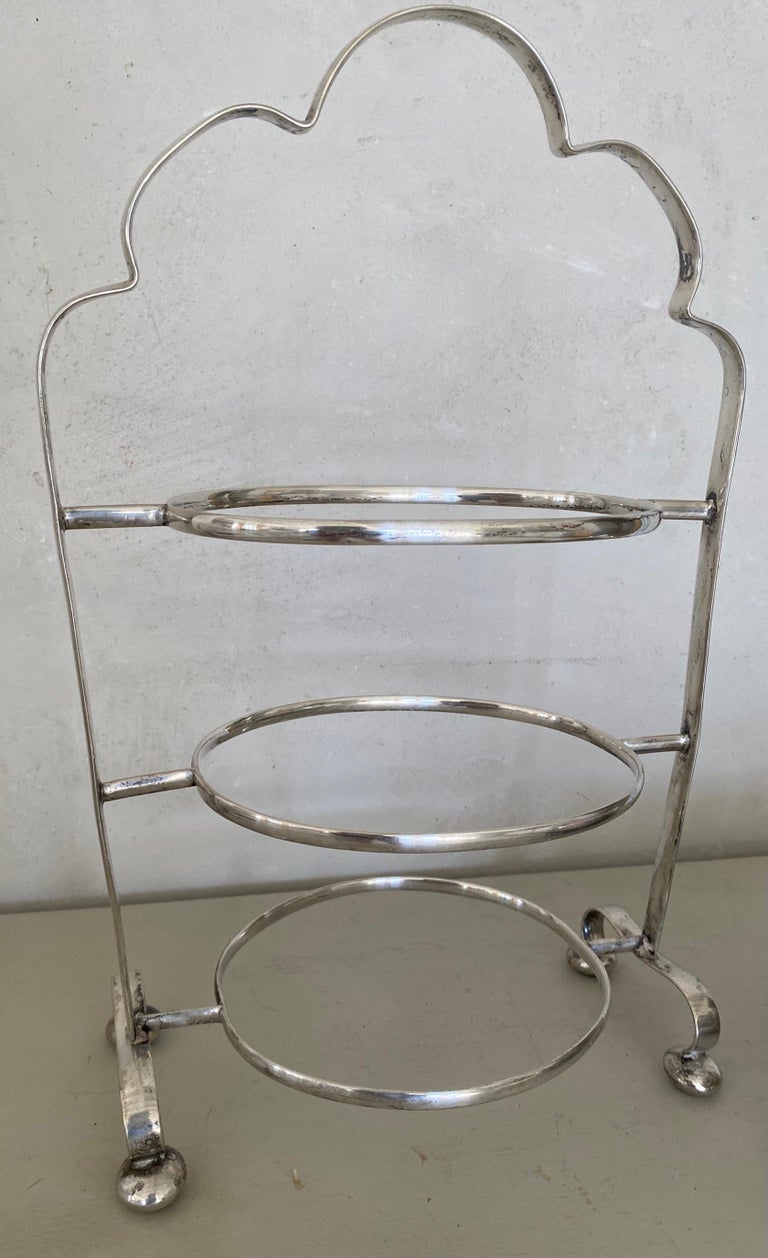 Add timeless elegance to your entertaining experience with this rare silver-plated three-tiered cake stand with three filigreed plates. Great for serving afternoon high tea a la Downton Abby. Perfect for tidbits, appetizers, small finger sandwiches,