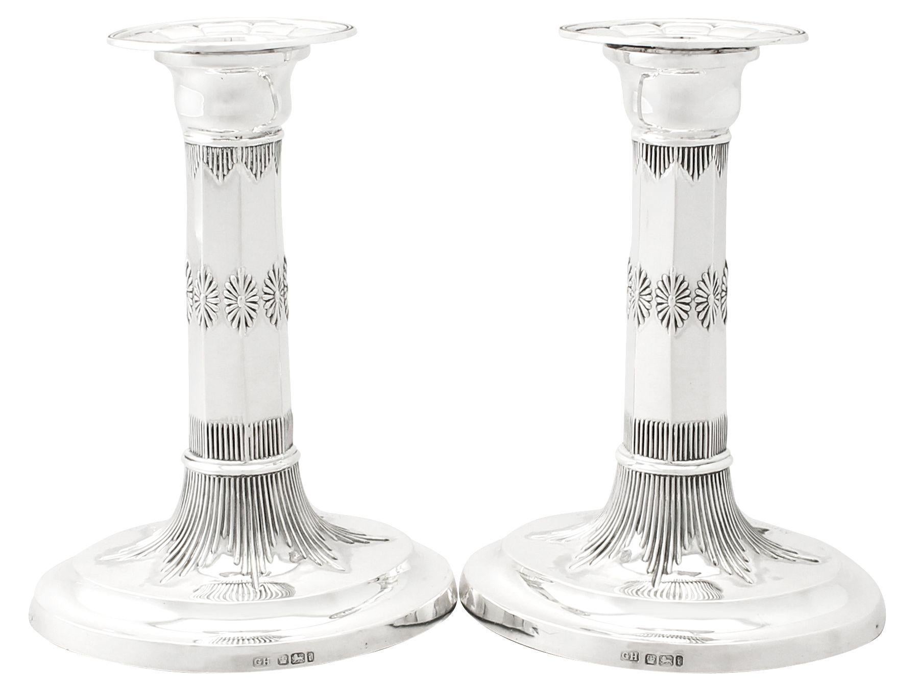 A fine and impressive pair of antique Edwardian English sterling silver candlesticks with sporting interest; an addition to our diverse ornamental silverware collection. 

These fine antique Edwardian sterling silver candlesticks have plain