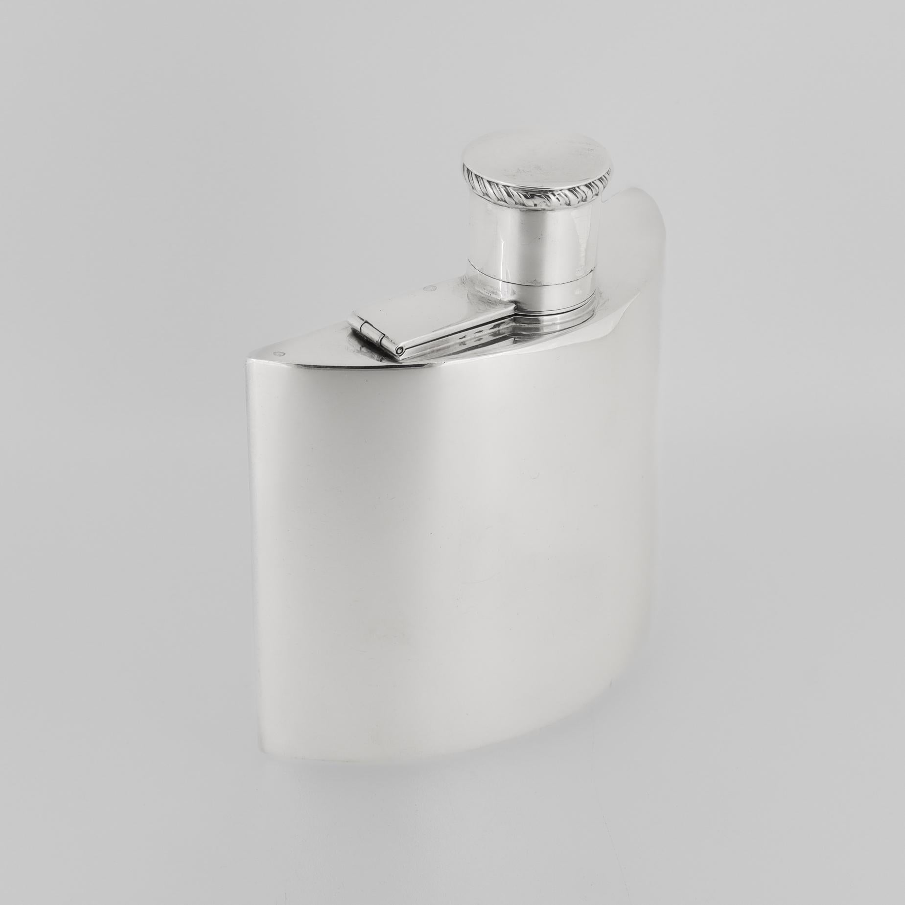 Un'elegante fiaschetta inglese per liquori o whisky.

In argento sterling.

Da Charles S. Green & Co. Silversmith Co. di Birmingham, Inghilterra.

Ha una forma a mezzaluna convessa, una parte superiore a torsione integrale e una base