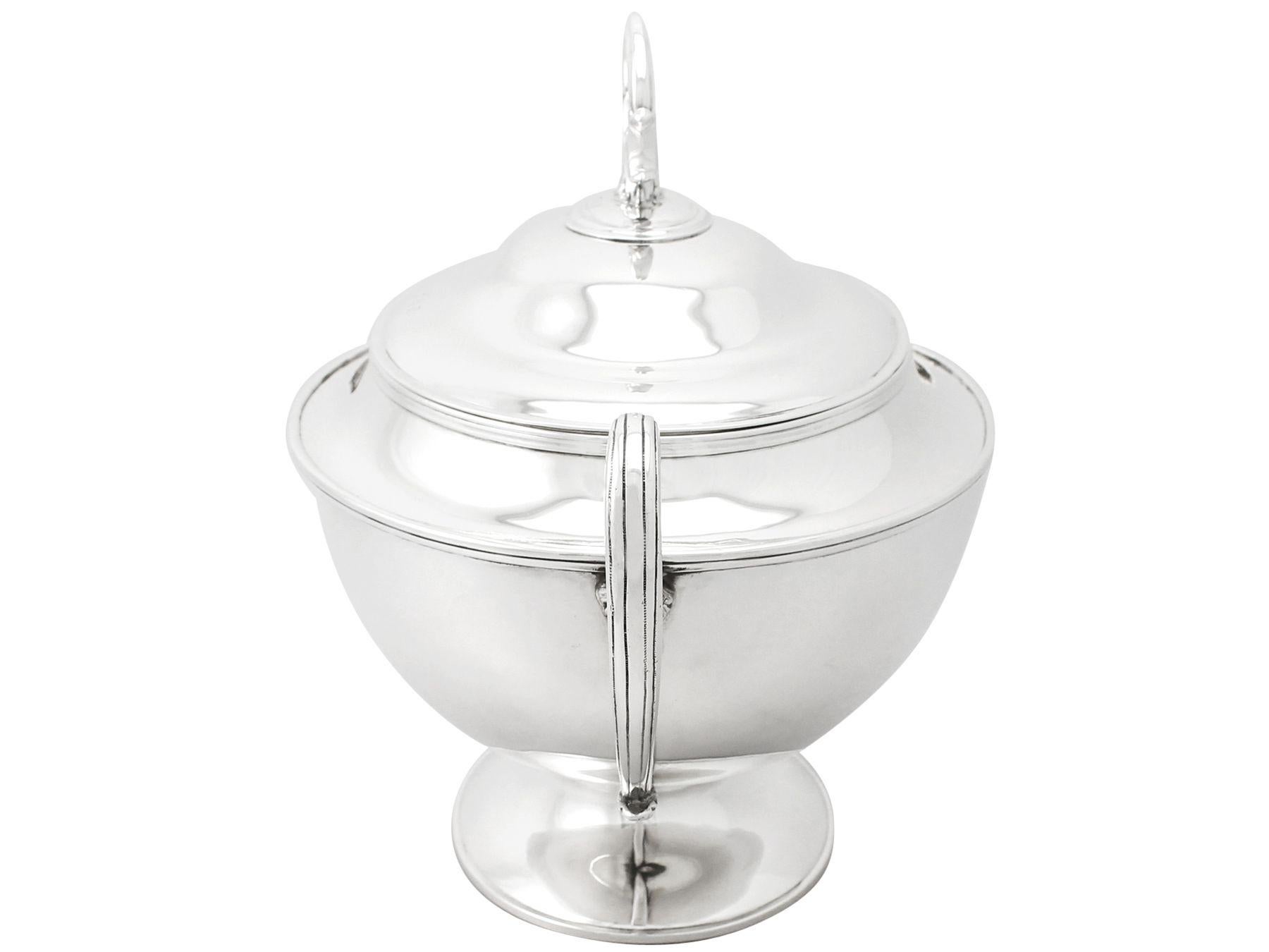 A fine and impressive antique Edwardian English sterling silver soup tureen; an addition to our silver dining collection

This fine antique Edwardian sterling silver soup tureen has a plain oval shaped form onto a plain oval domed spreading